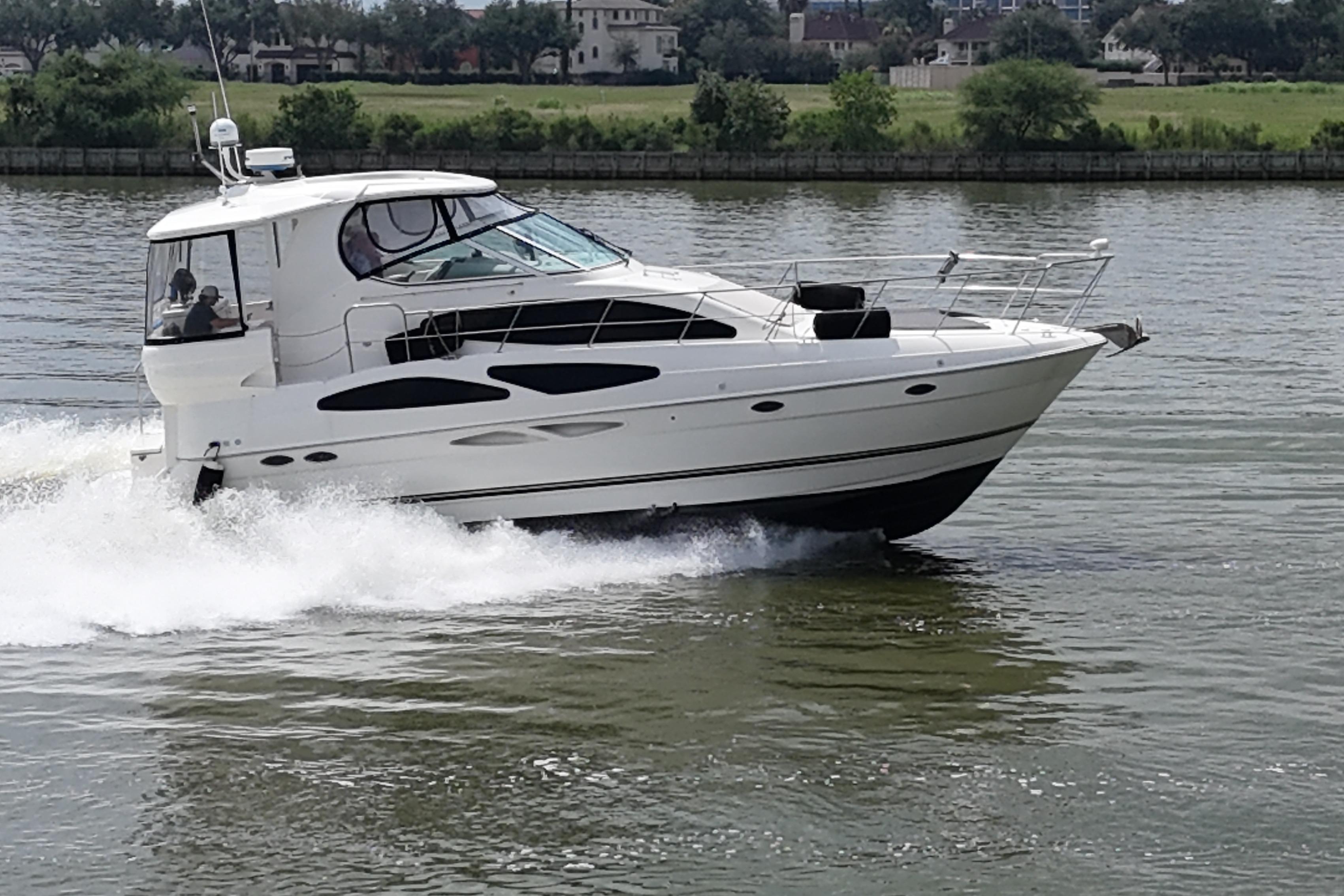 2004 Cruisers Yachts 405 Express Motoryacht cruising on a calm river.