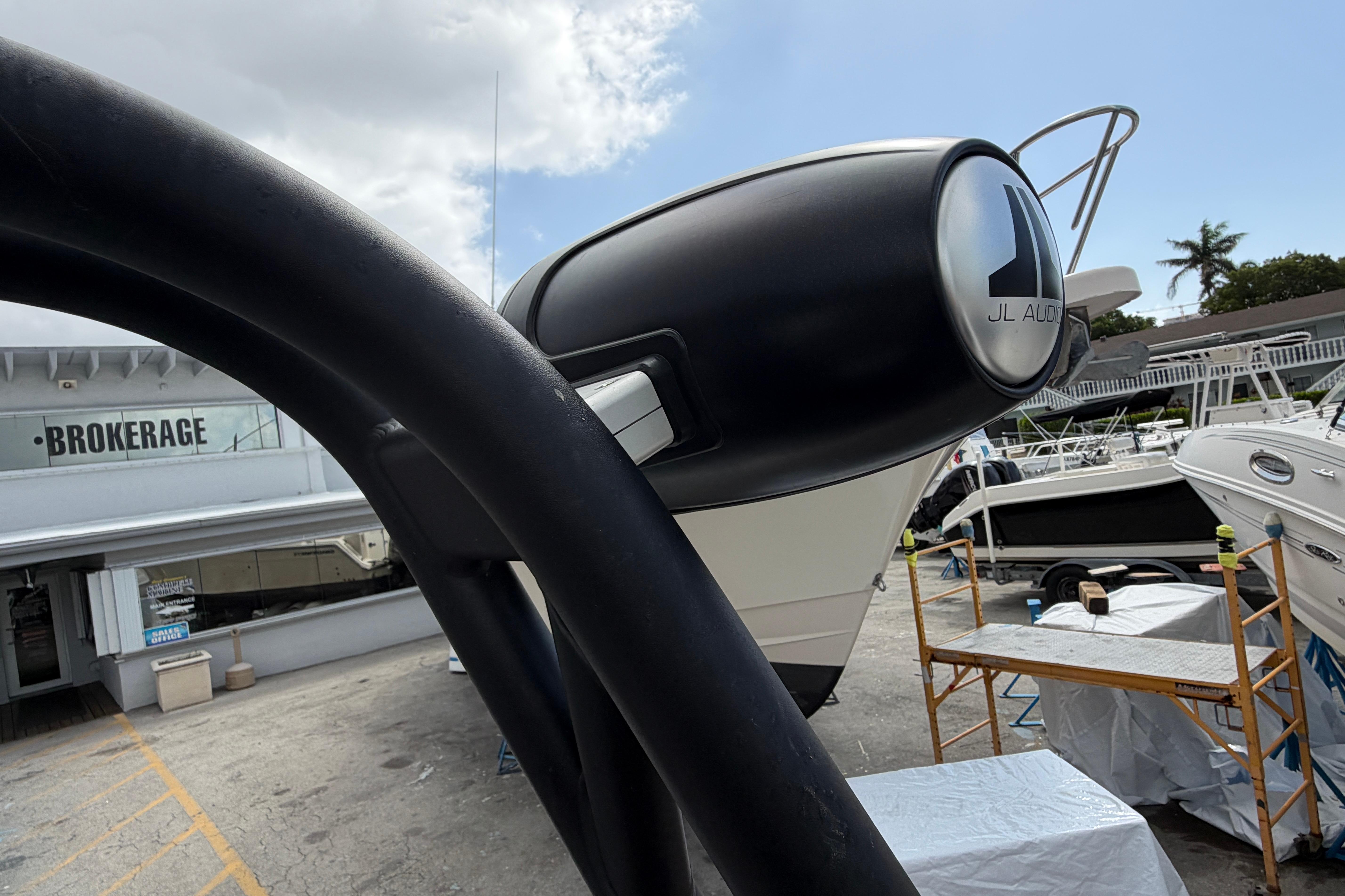 2026 Scarab 235 LX boat with JL Audio speakers at a brokerage.