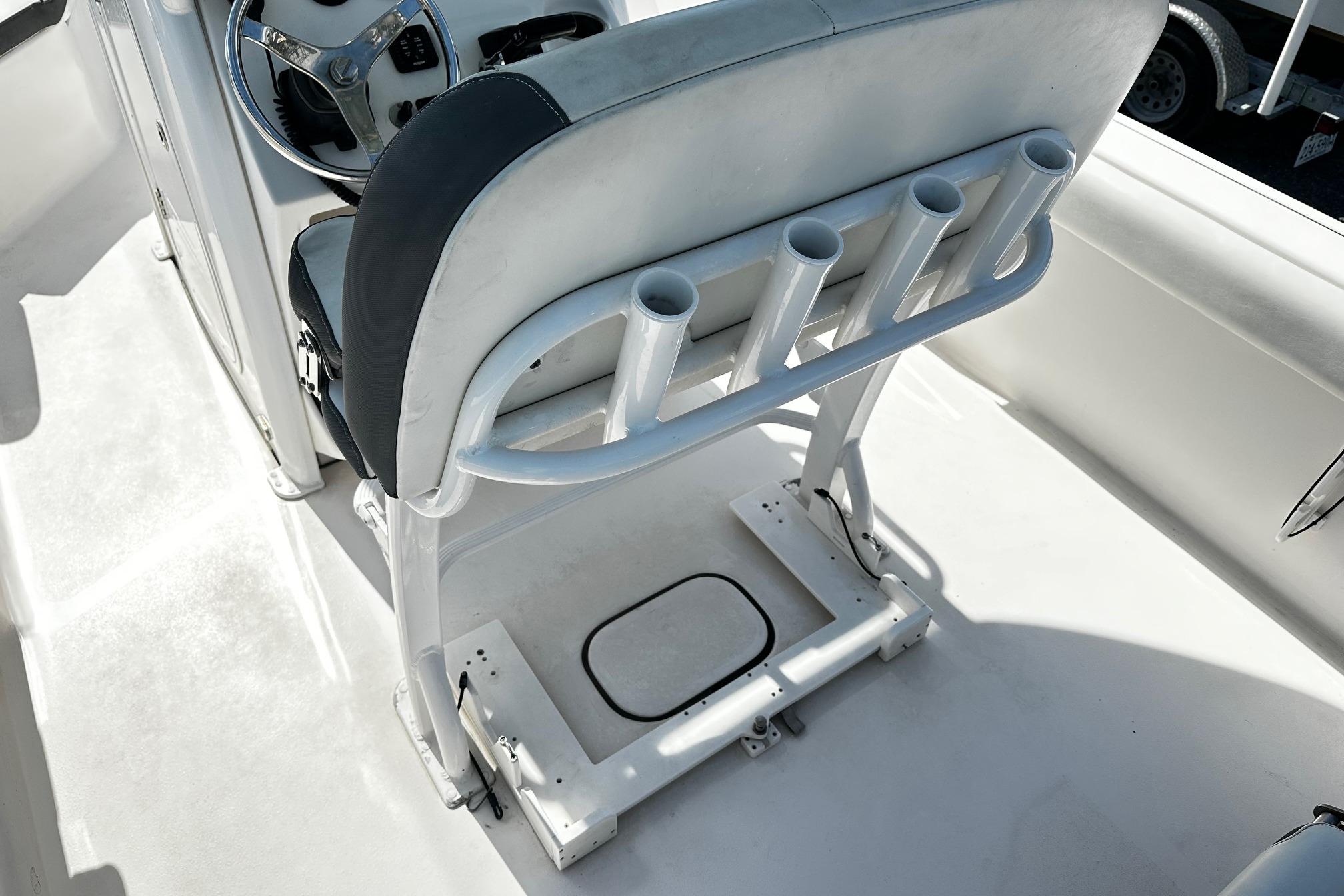 2020 Tidewater 230 CC Adventure boat interior with steering wheel and rod holders.