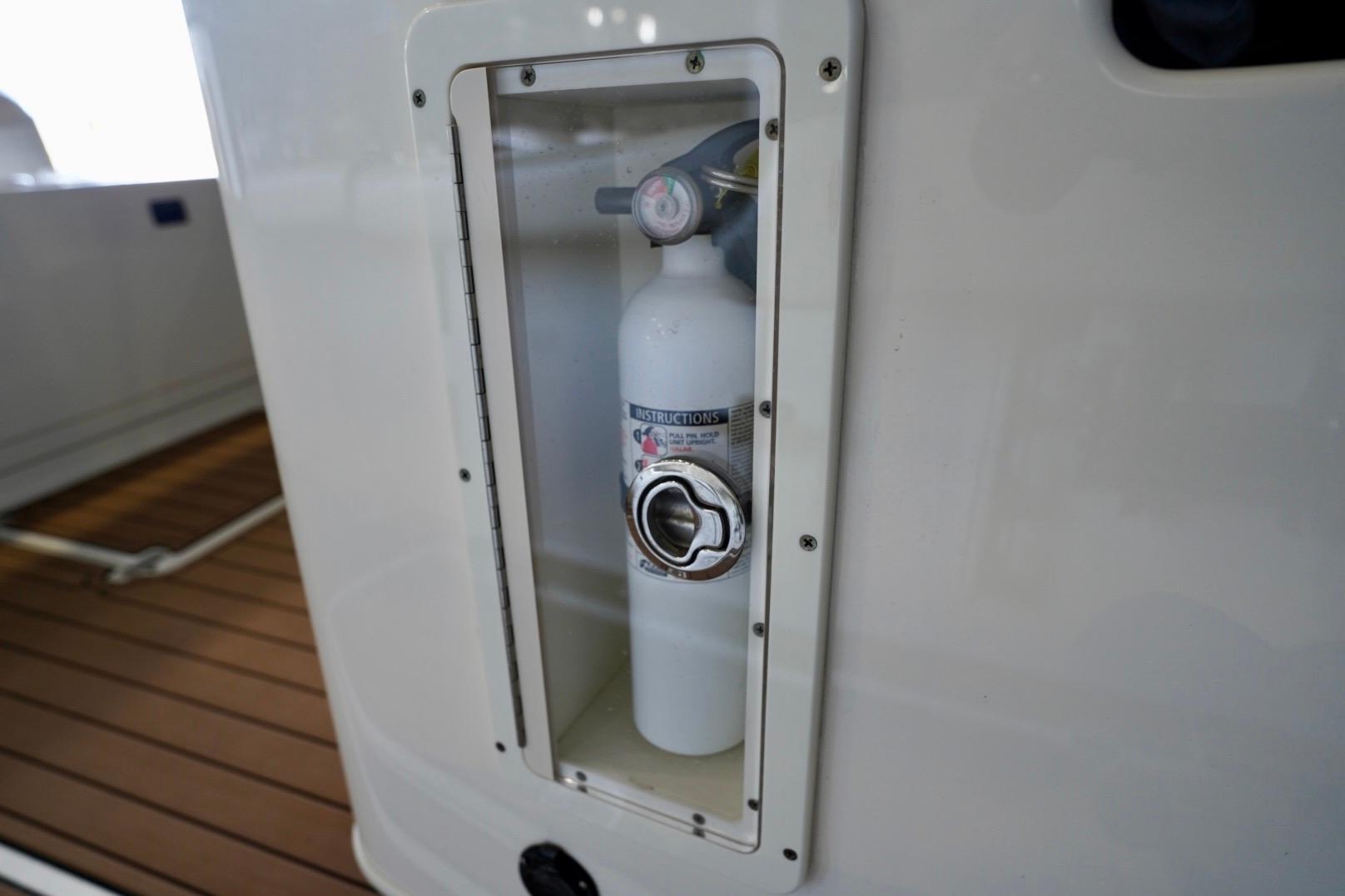 Fire extinguisher compartment on 2019 Cobia 344 Center Console boat.