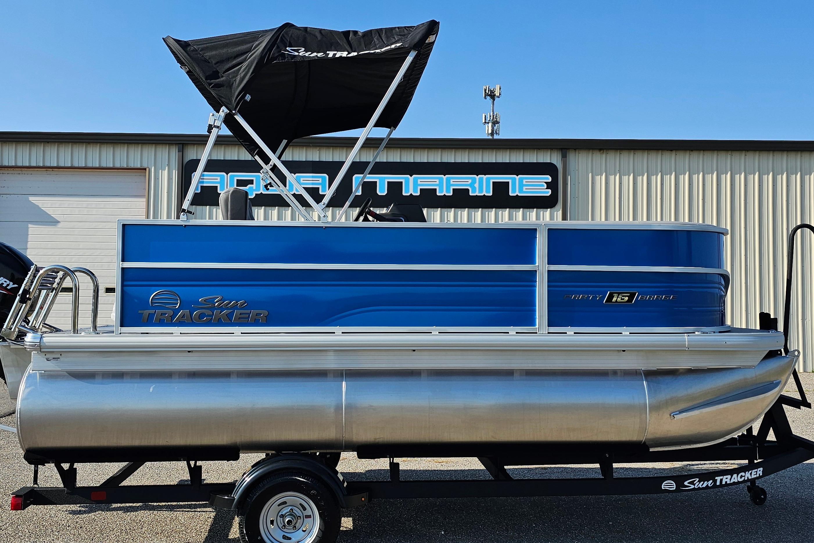 2026 Sun Tracker Party Barge 16 DLX pontoon boat with blue exterior and canopy.