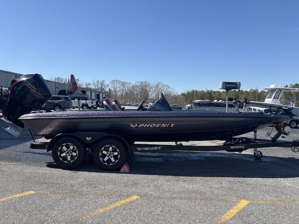 2025 Phoenix 920 Elite boat on trailer, parked outdoors under clear blue sky.