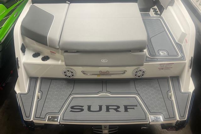 2025 Cobalt CS23 Surf boat with sleek design and spacious seating area.