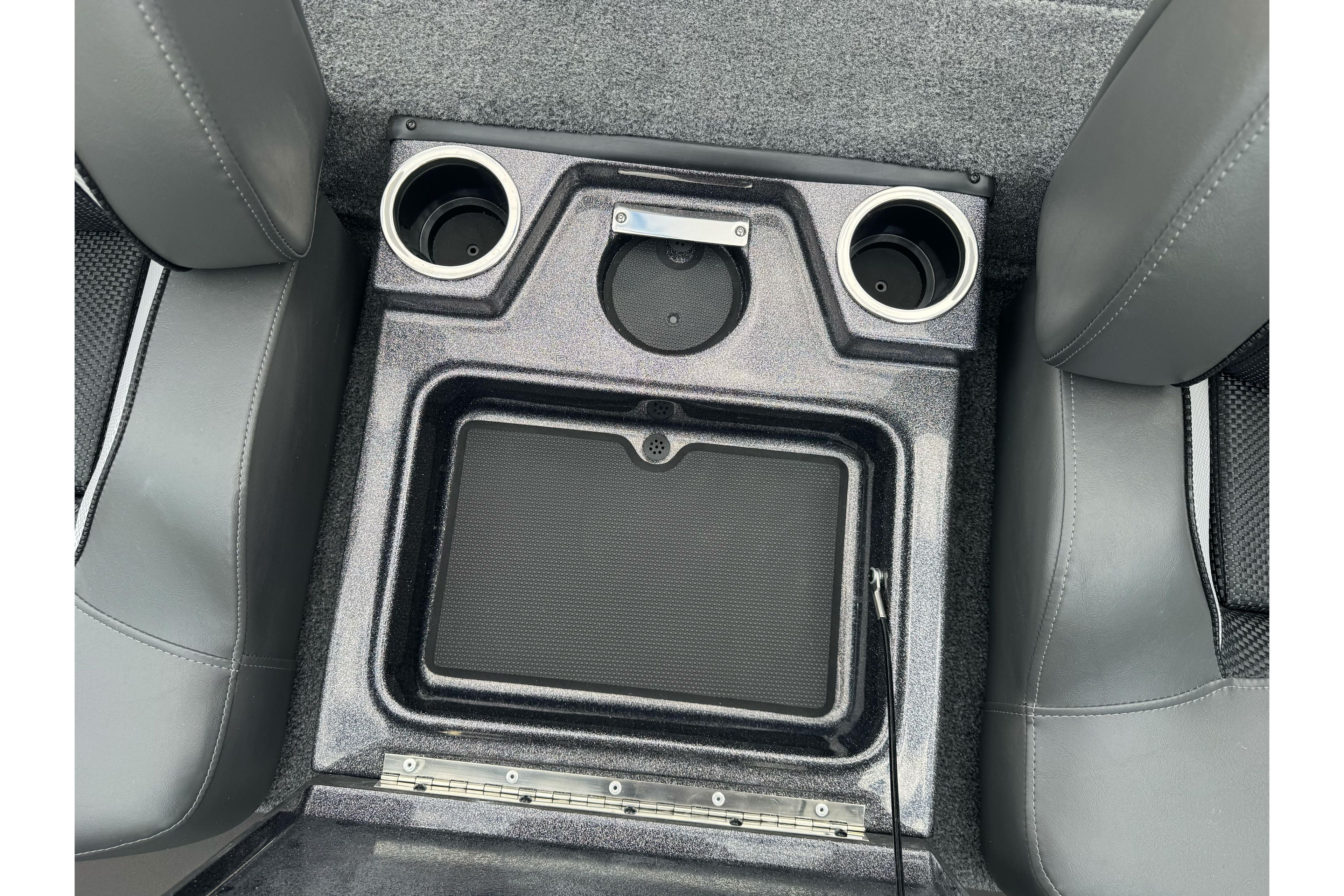 Center console of 2026 Ranger ALPHA 208 with cup holders and storage compartment.