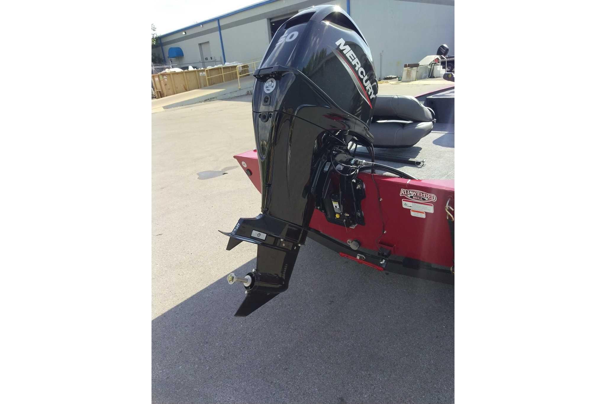 2026 Tracker Bass Tracker Classic XL with Mercury outboard motor in a parking lot.