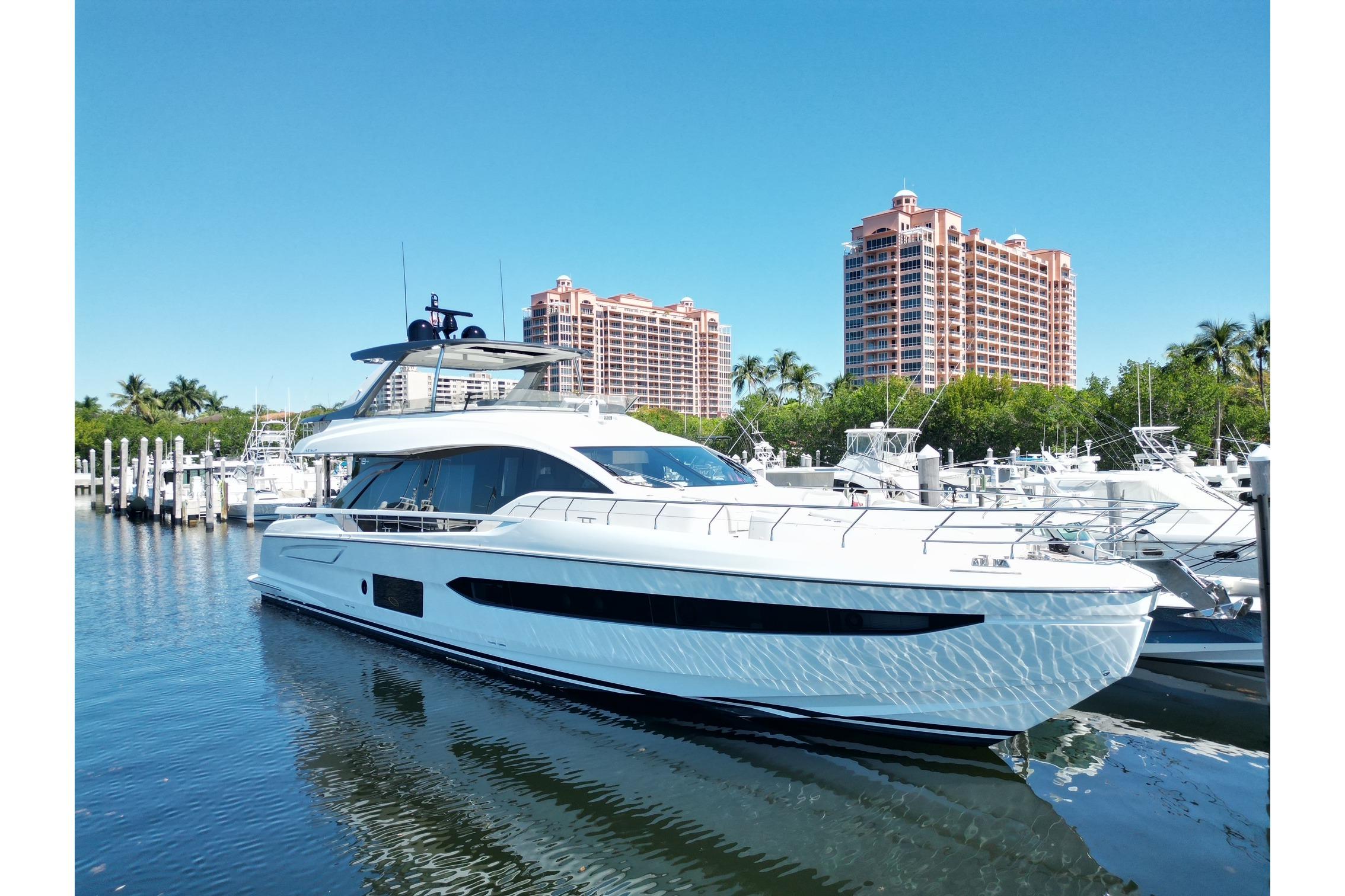 2022 Azimut Fly 78 yacht docked in marina with luxury buildings in background.