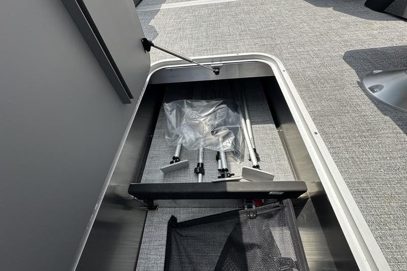 Storage compartment in 2026 Flamingo Rove 24' boat with accessories and tools.