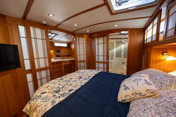 Interior of 2020 Sabre Salon Express 48 yacht, featuring a luxurious bedroom with wood paneling.