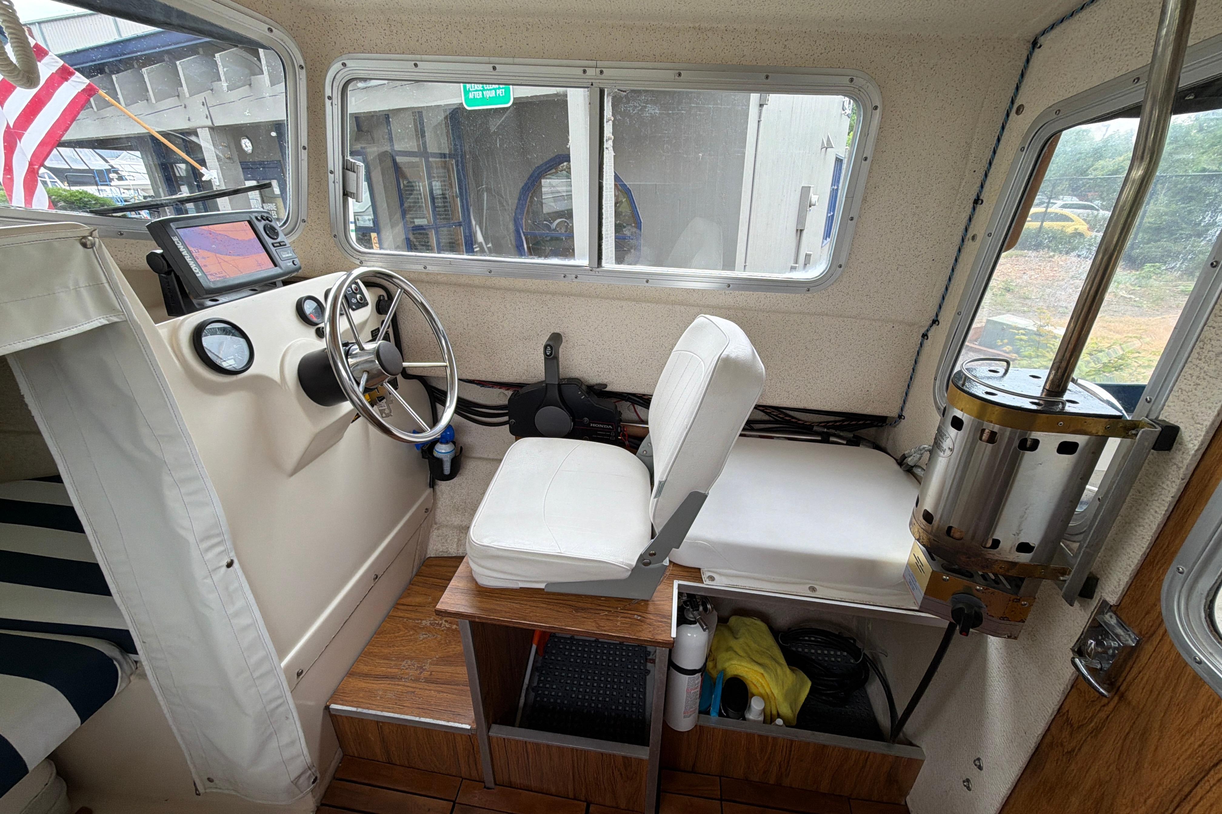 Interior of a 1989 C-Dory 22' Angler boat with steering wheel and navigation equipment.