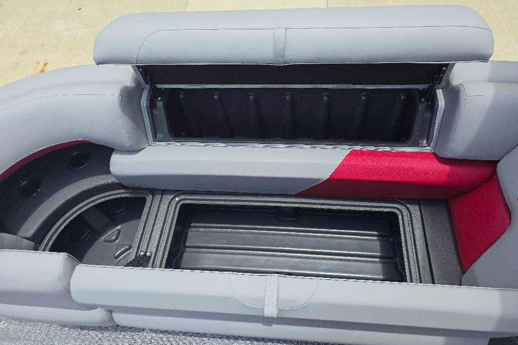 2026 Sun Tracker Party Barge 20 DLX seating with open storage compartments.