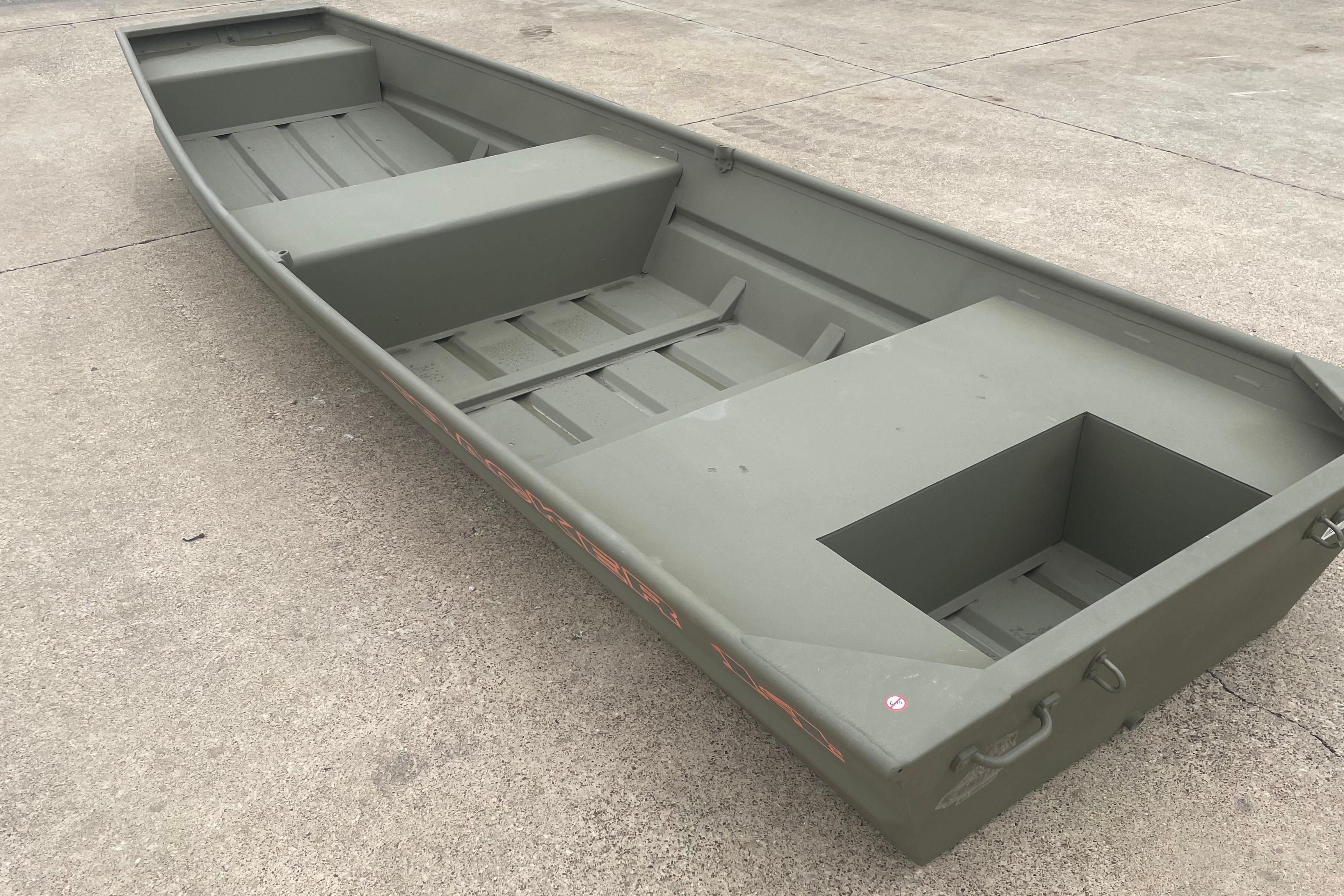 2026 Tracker Grizzly 14 Jon boat on concrete surface, showcasing spacious interior design.