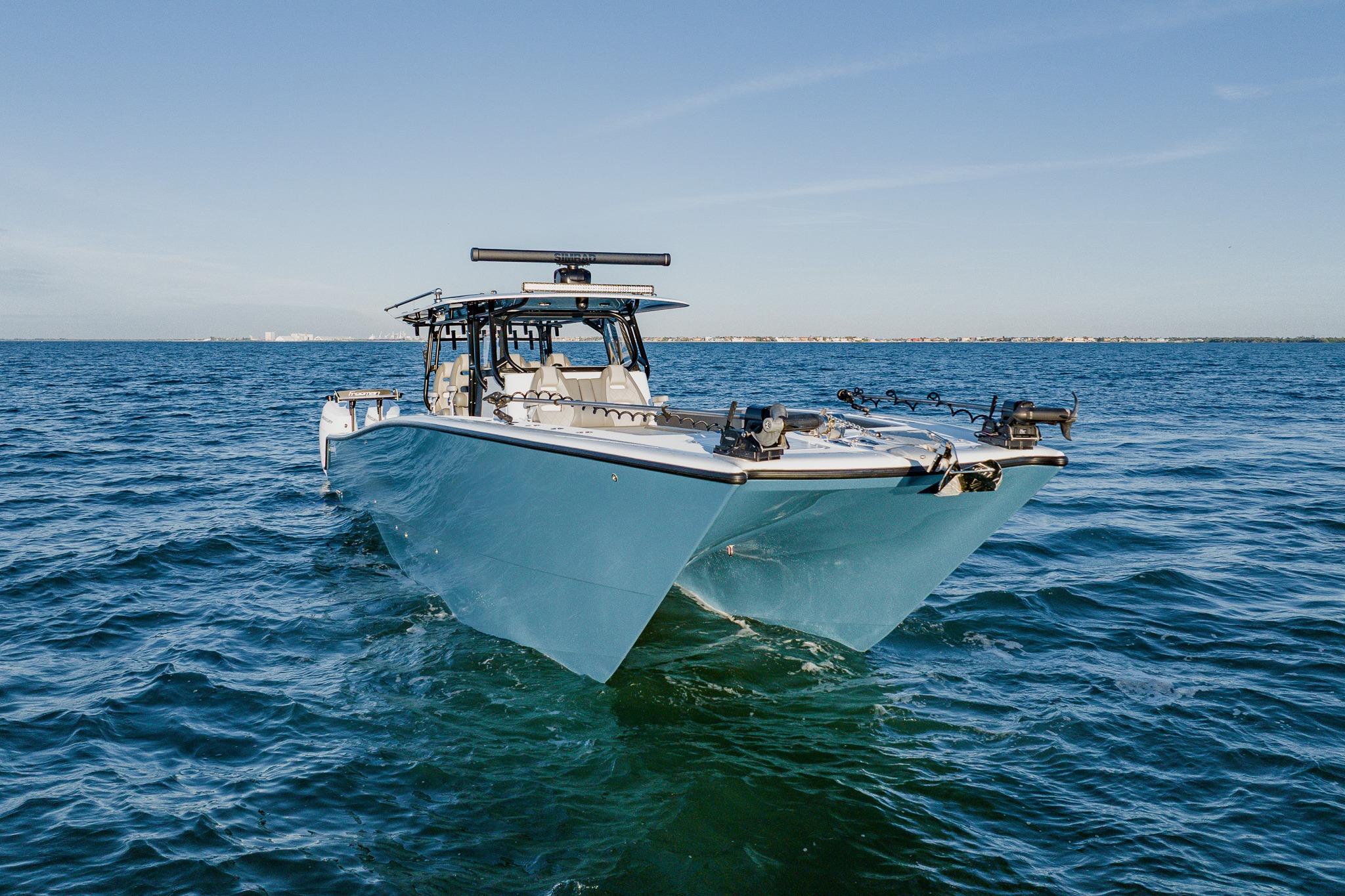 Freeman 42LR 2025 boat cruising on open water under clear blue sky.
