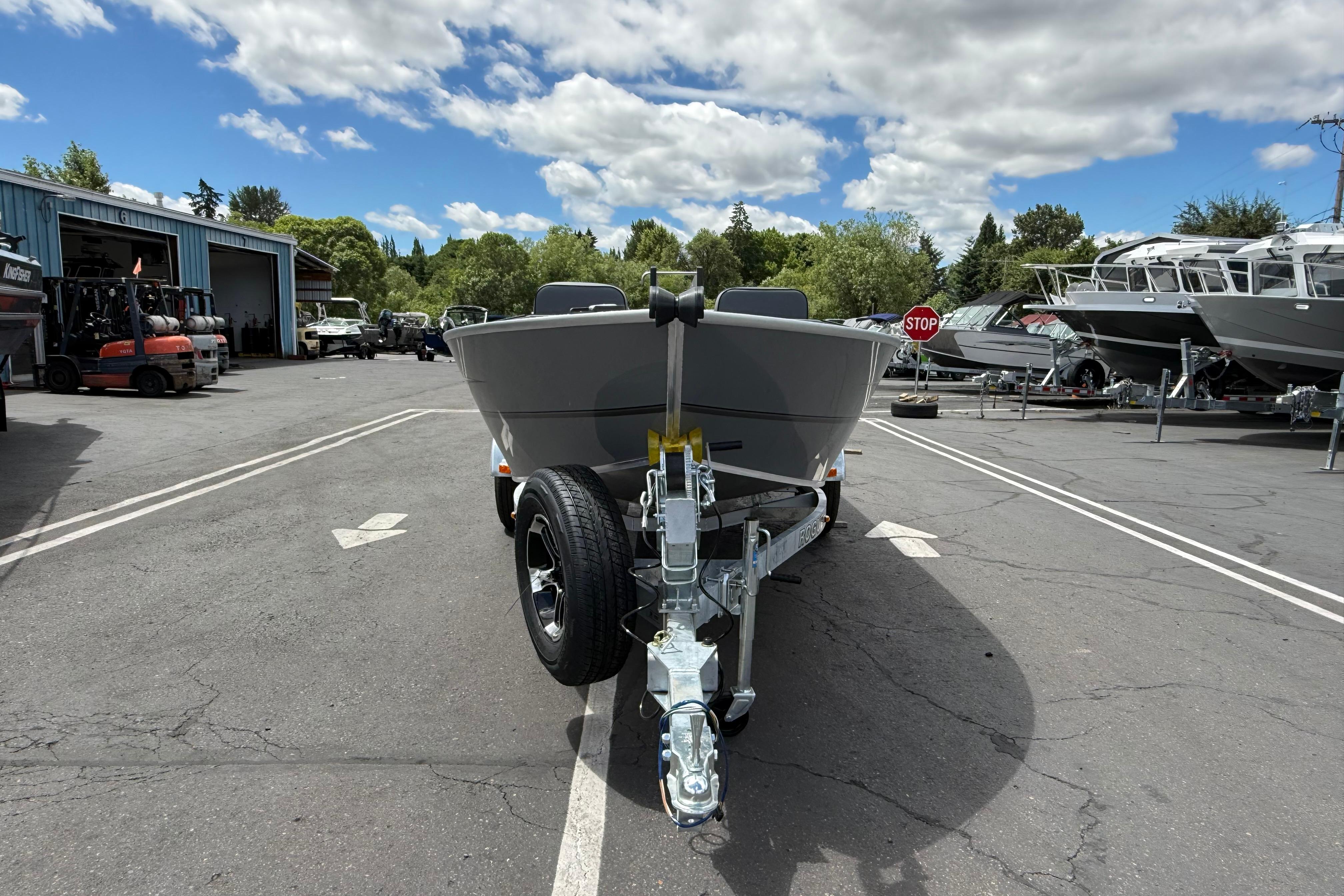 2026 Alumaweld Free Drifter 20 boat on trailer in a dealership lot.