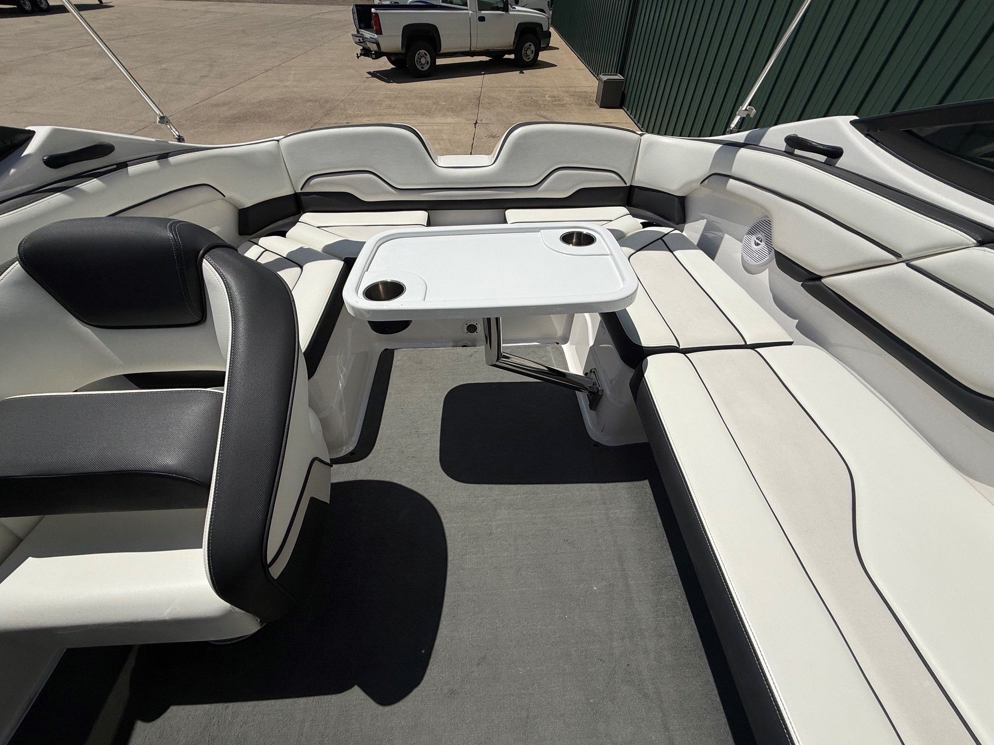 Interior of a Yamaha SX210 boat with seating and a table.