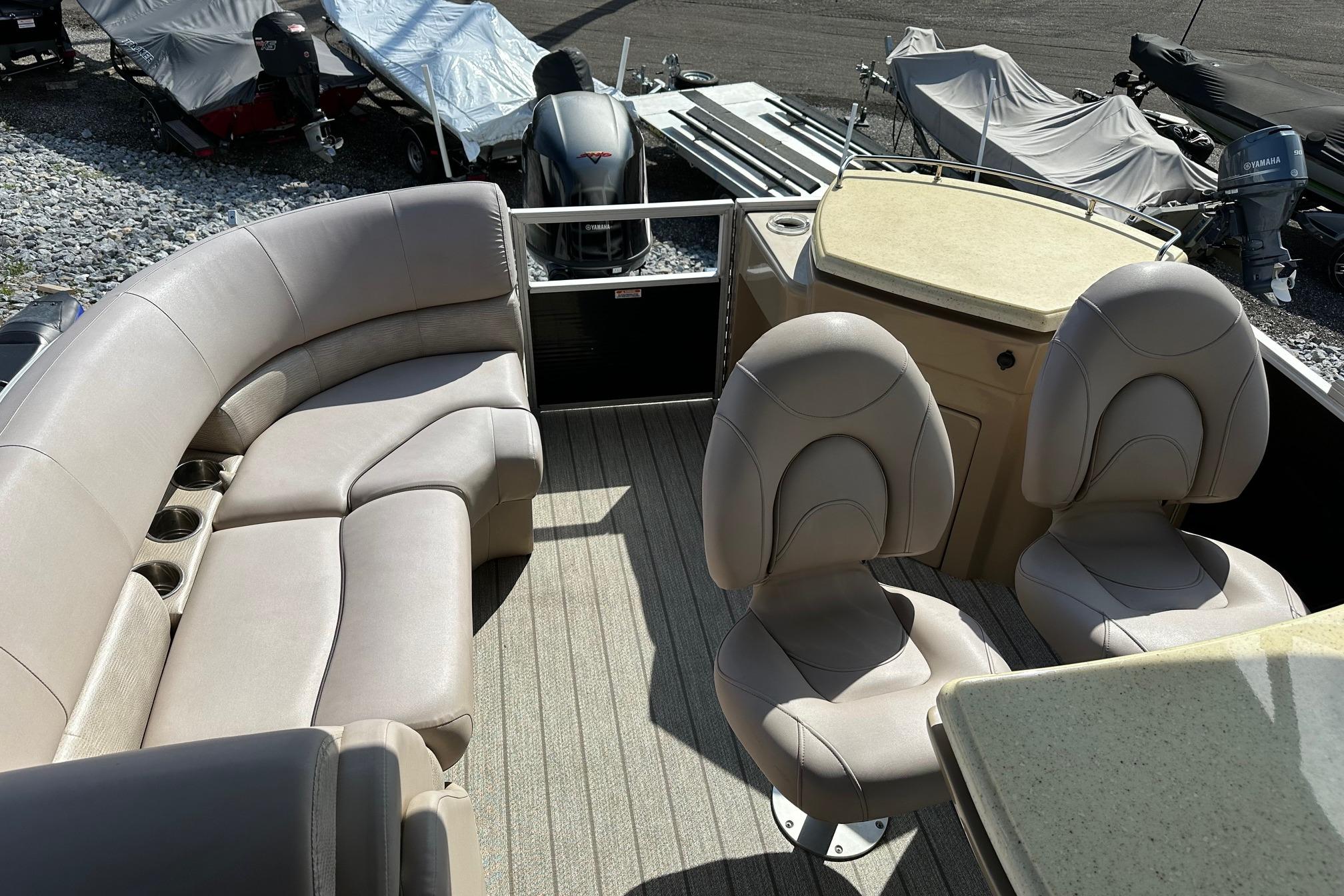 2017 Bennington 22 GPD boat interior with beige seating and cup holders.