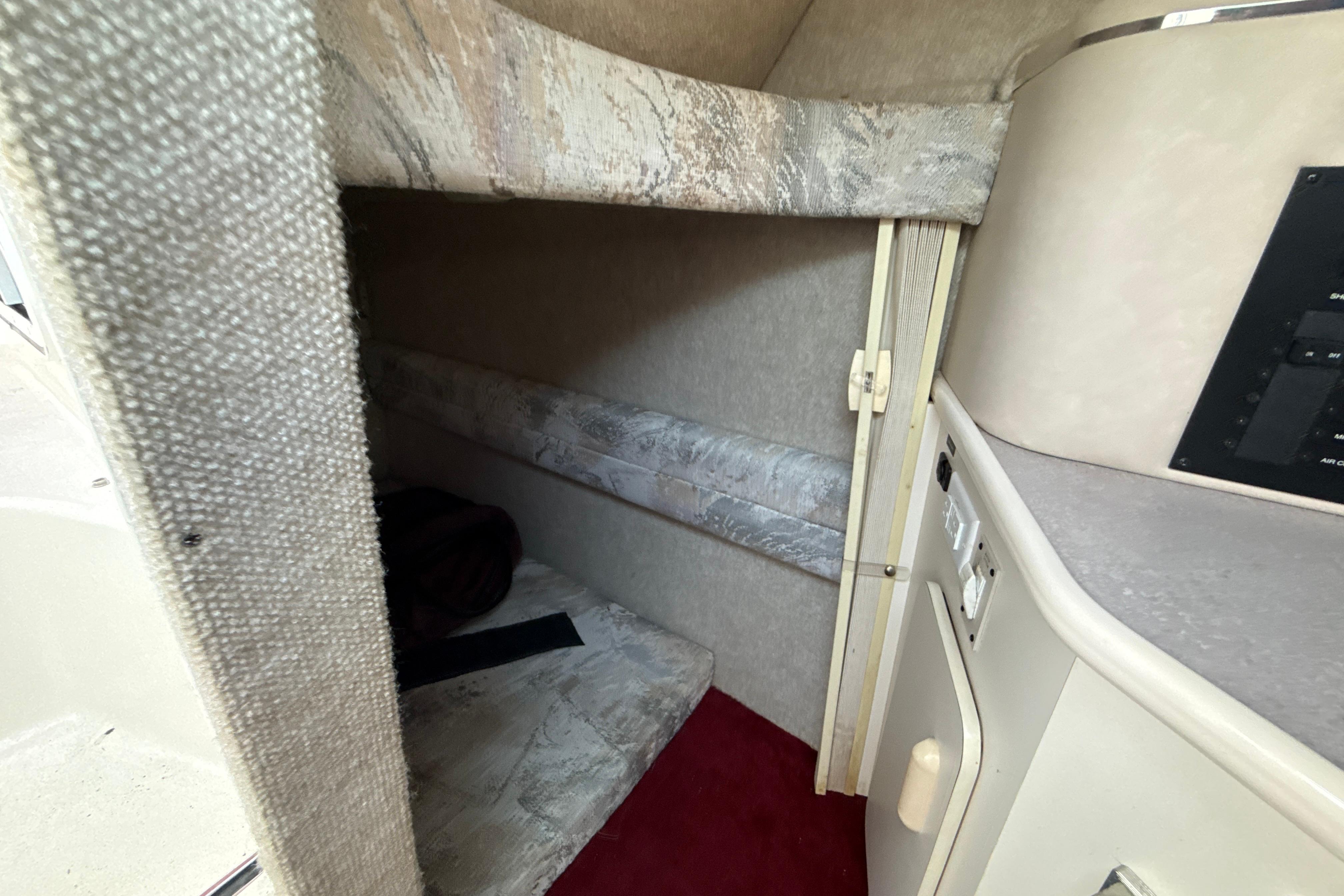 Interior cabin of 1996 Sea Ray 240 Sundancer boat, featuring cozy sleeping area.