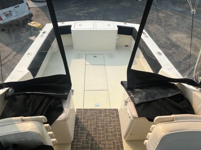 Interior of a 2002 Carolina Classic 25 boat, featuring seating and storage.