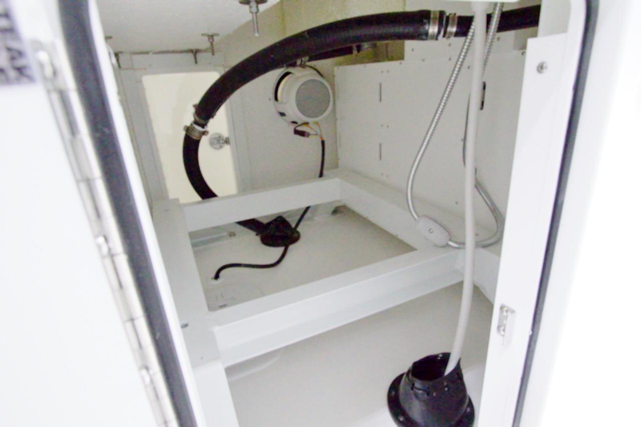 Interior view of 2026 Regulator 31 boat compartment with hoses and wiring.