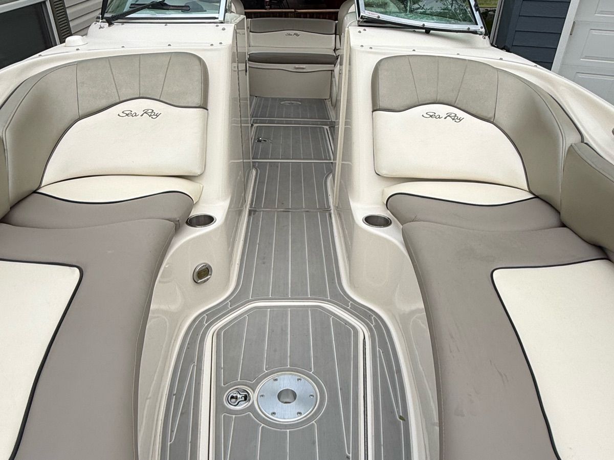 The image shows the cockpit of a 2007 Sea Ray 240 Sundeck with beige and gray upholstery.