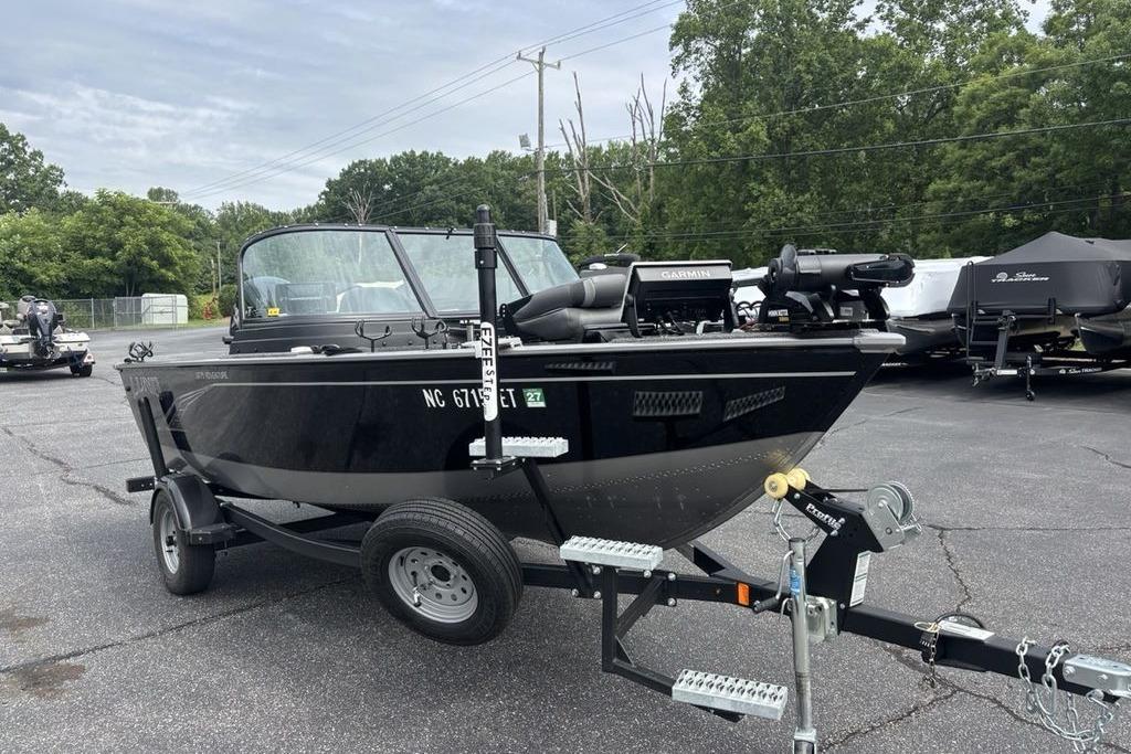 2021 Lund 1675 Adventure Sport boat on trailer in parking lot.