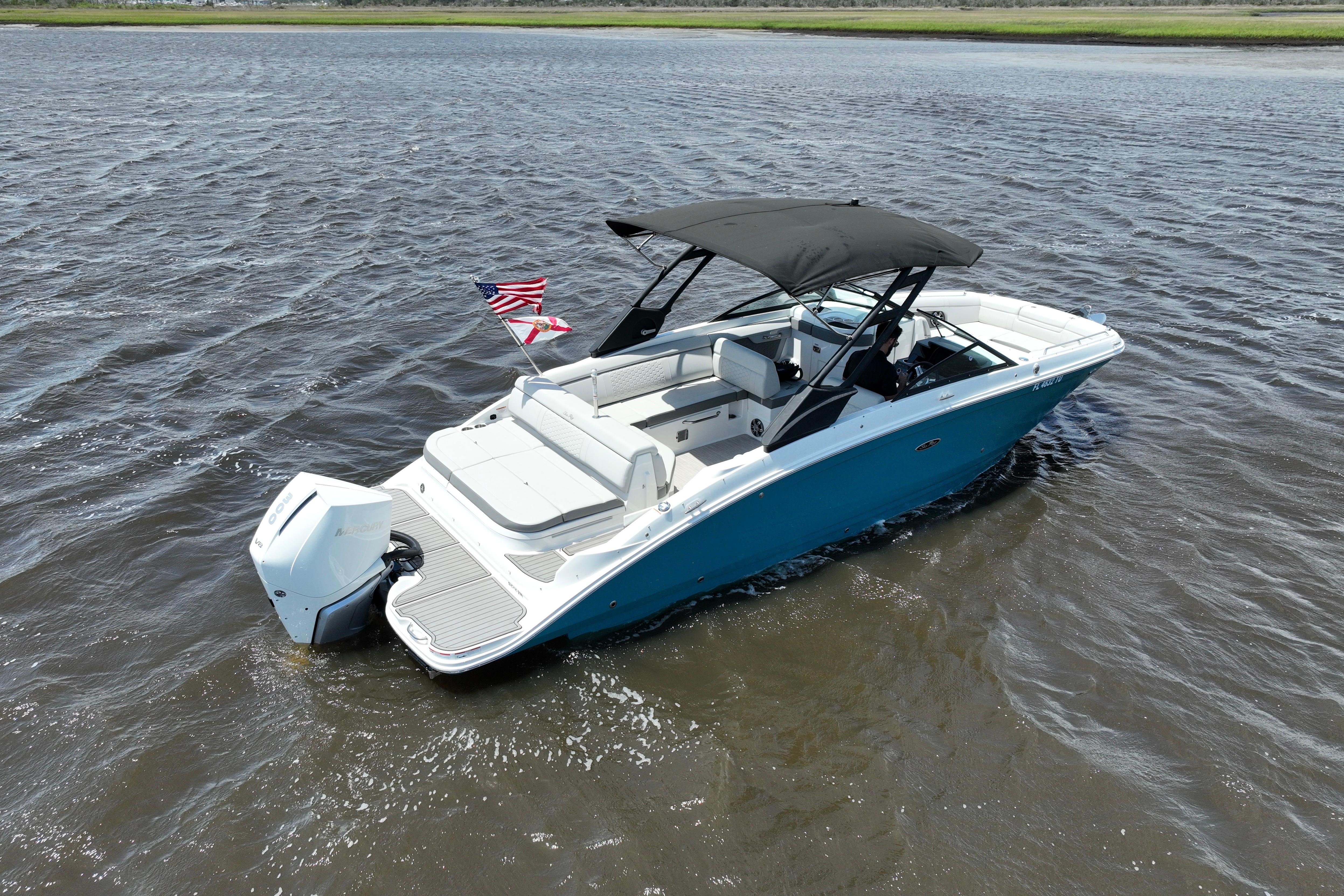 2024 Sea Ray SDX 270 Outboard boat on water, featuring sleek design and American flag.