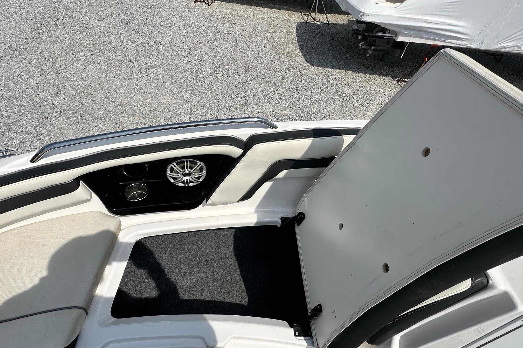 2016 Yamaha 242 Limited S boat interior with open storage compartment and speaker.