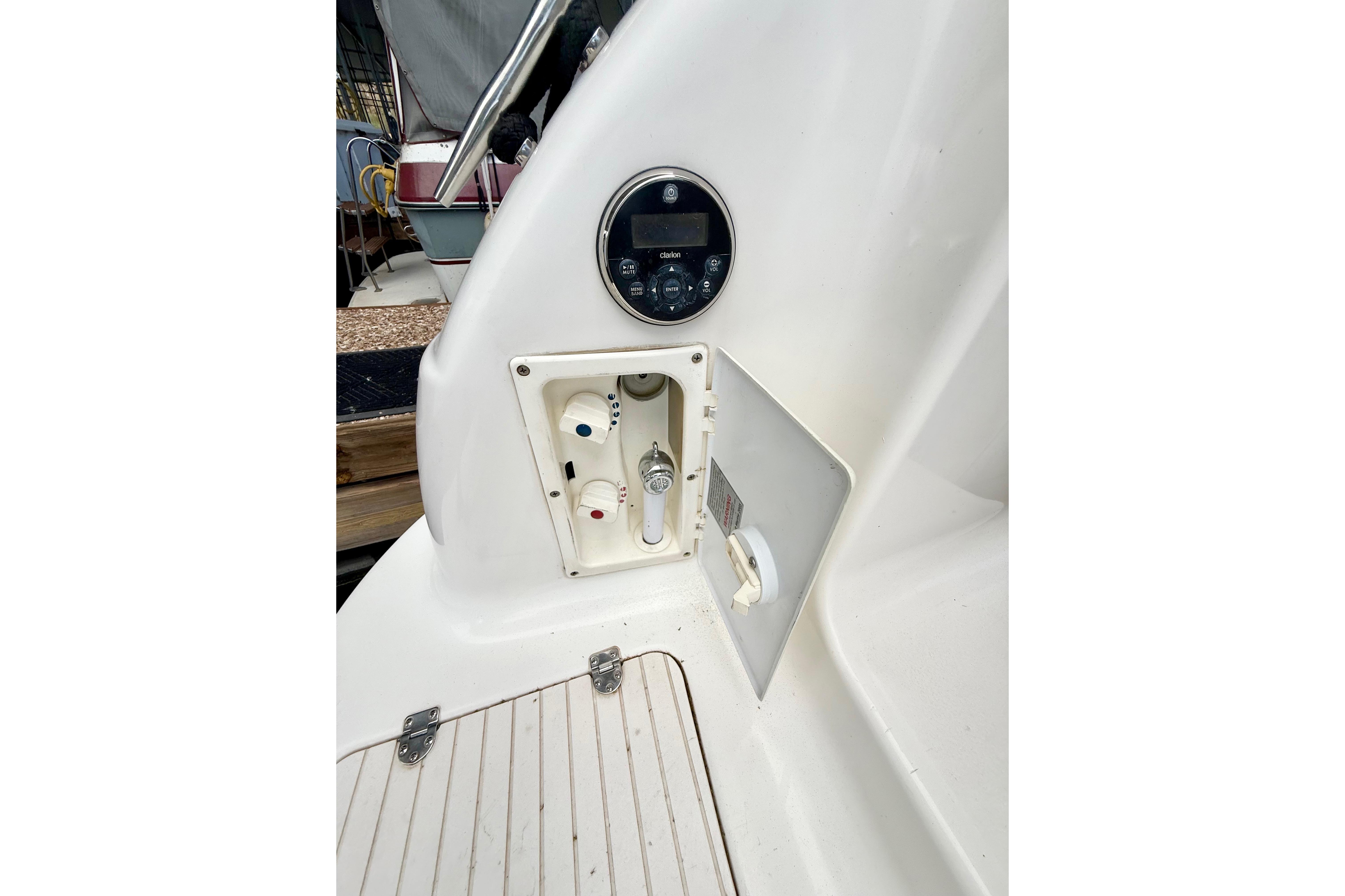 1999 Chaparral Signature 300 boat control panel and utility compartment.