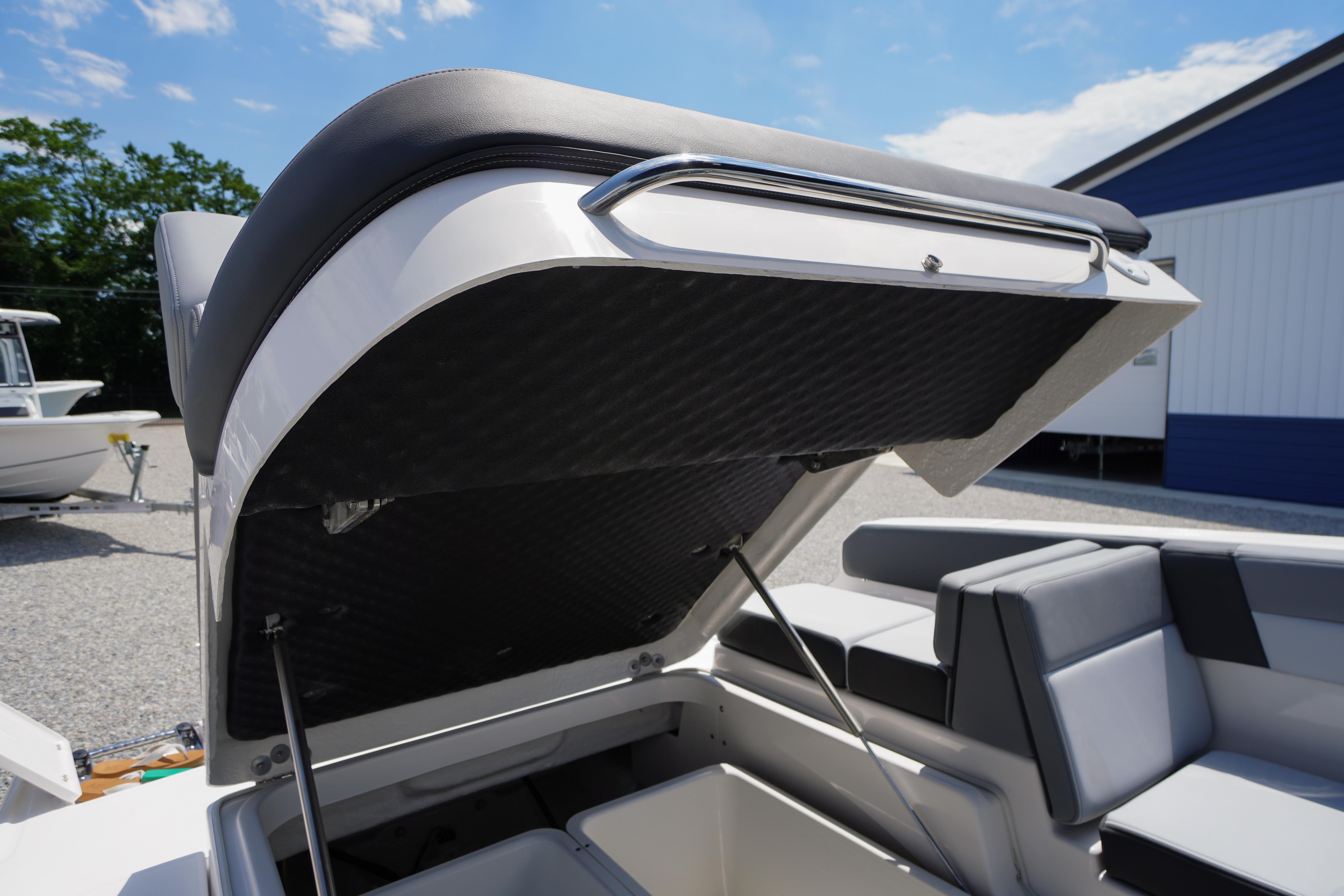 2026 Chaparral SSX 4 boat with open storage compartment, showcasing sleek interior design.