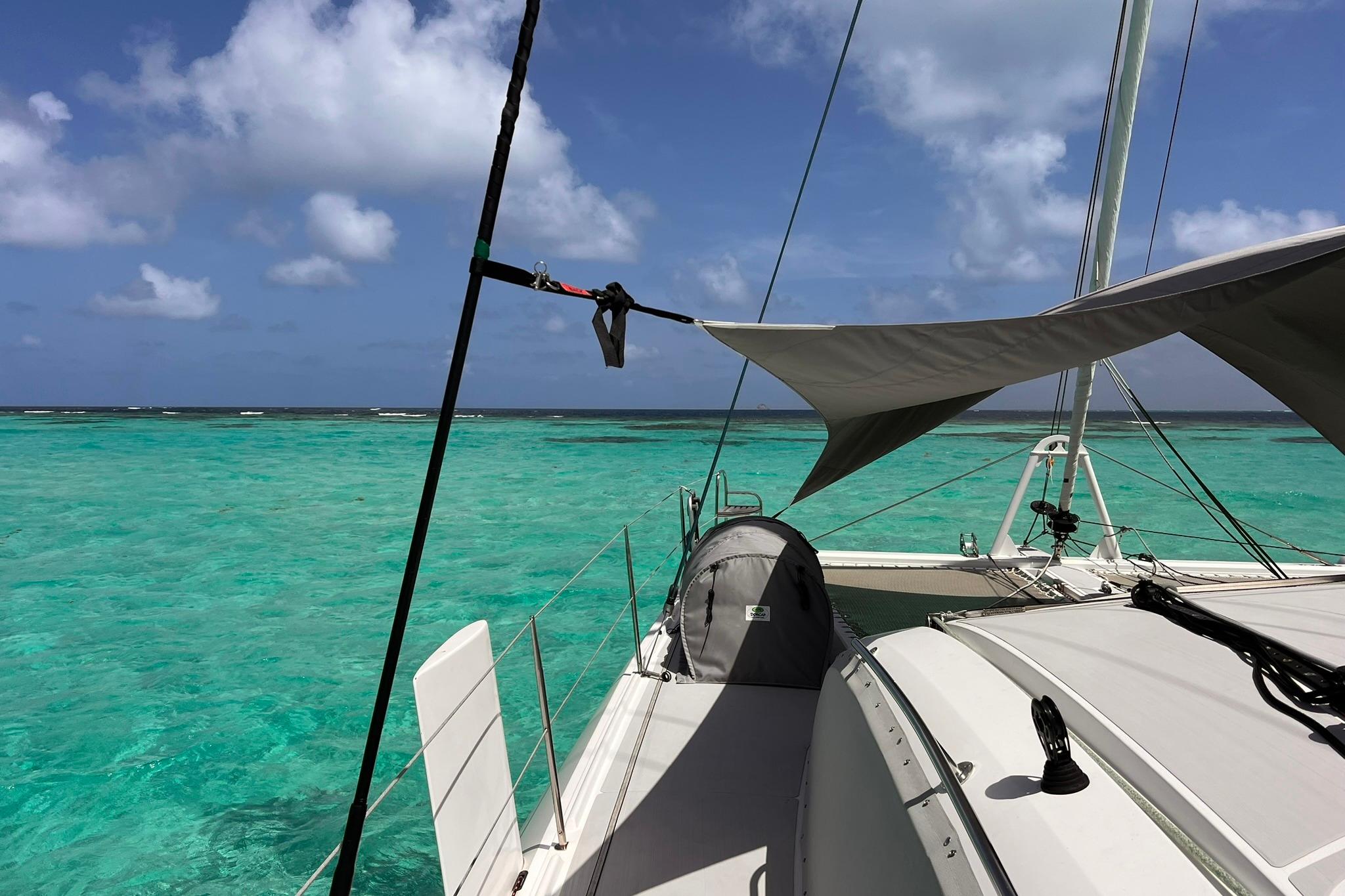 Outremer 51 catamaran sailing in turquoise waters, 2020 model, under clear blue skies.