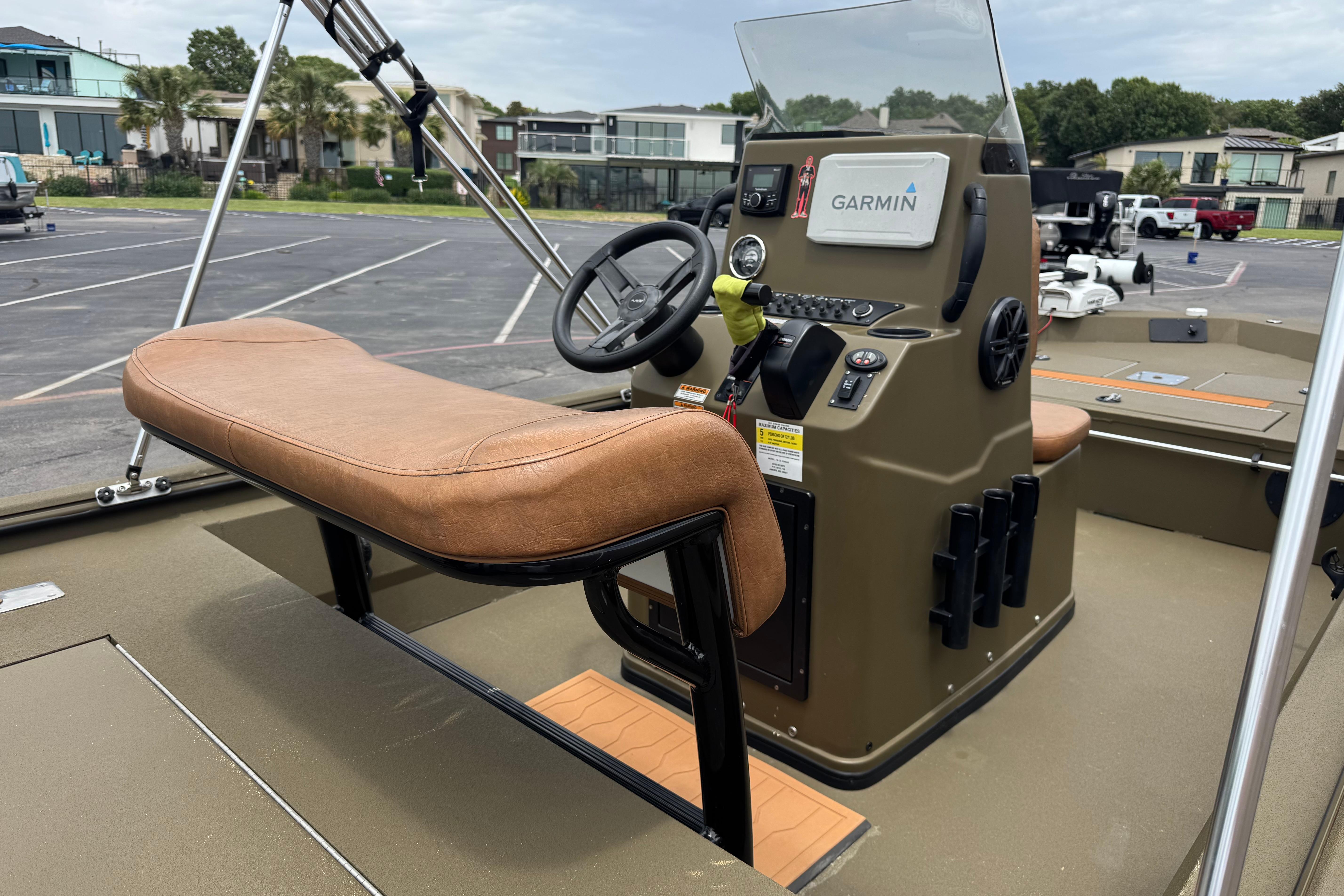 2023 Avid 18 Rogue CC boat console with Garmin navigation system and tan seating.