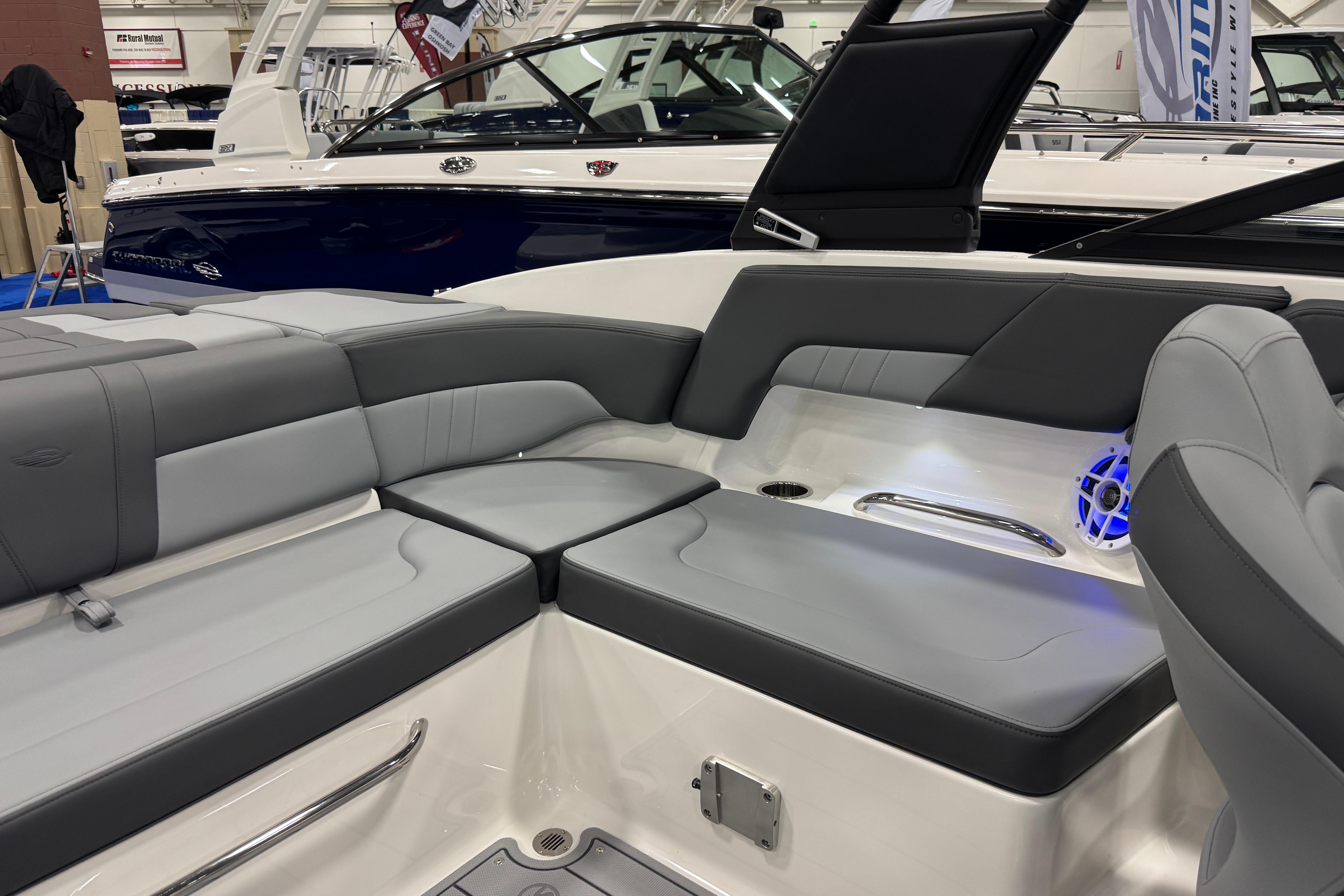 2026 Chaparral 23 SSi boat interior with gray seating and blue LED speaker.