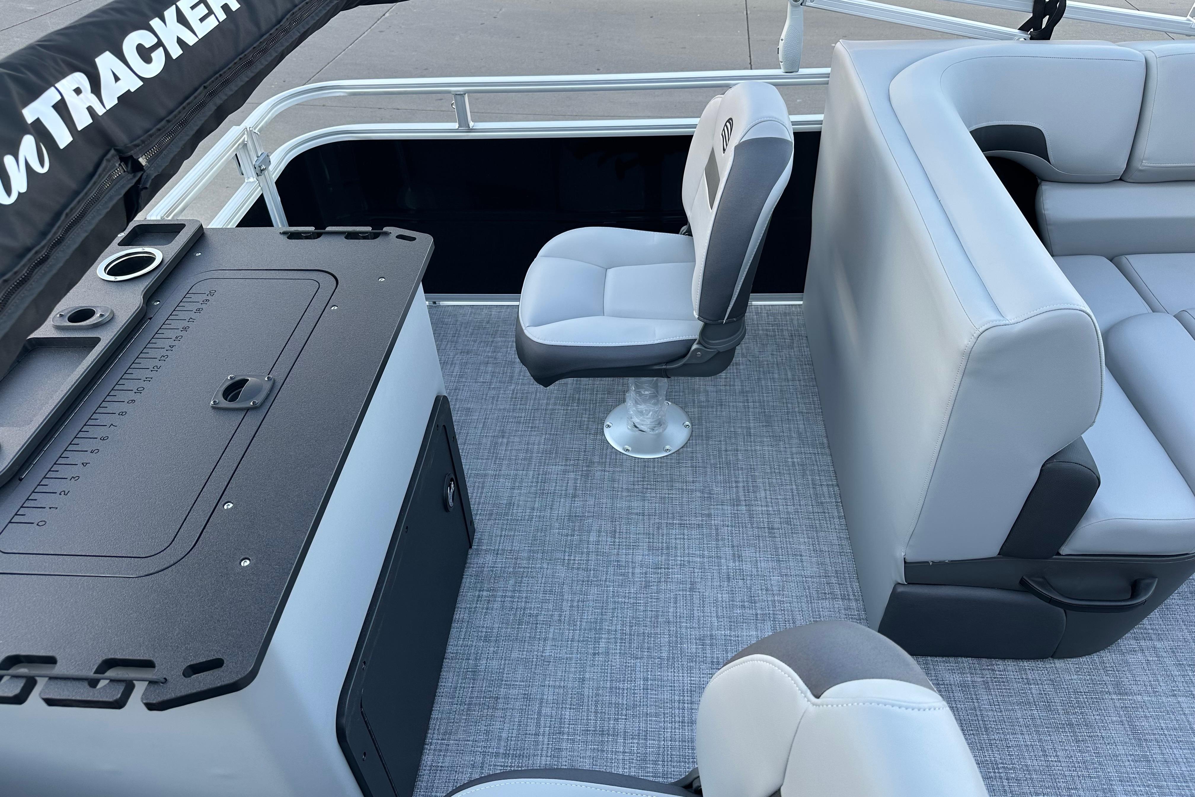 2026 Sun Tracker SportFish 22 DLX interior with seating and fishing station.