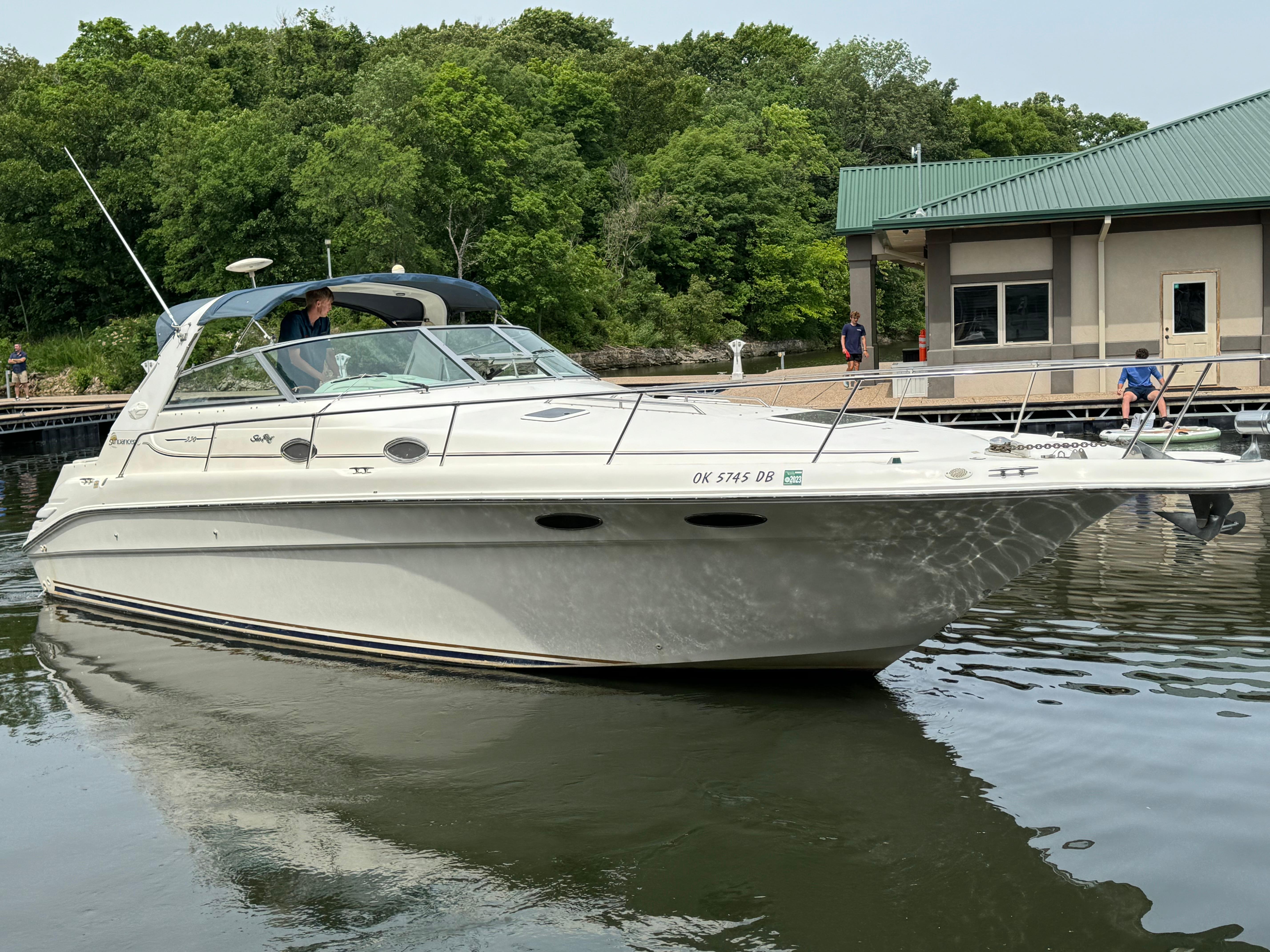1998 Sea Ray 330 Sundancer boat docked near a marina.