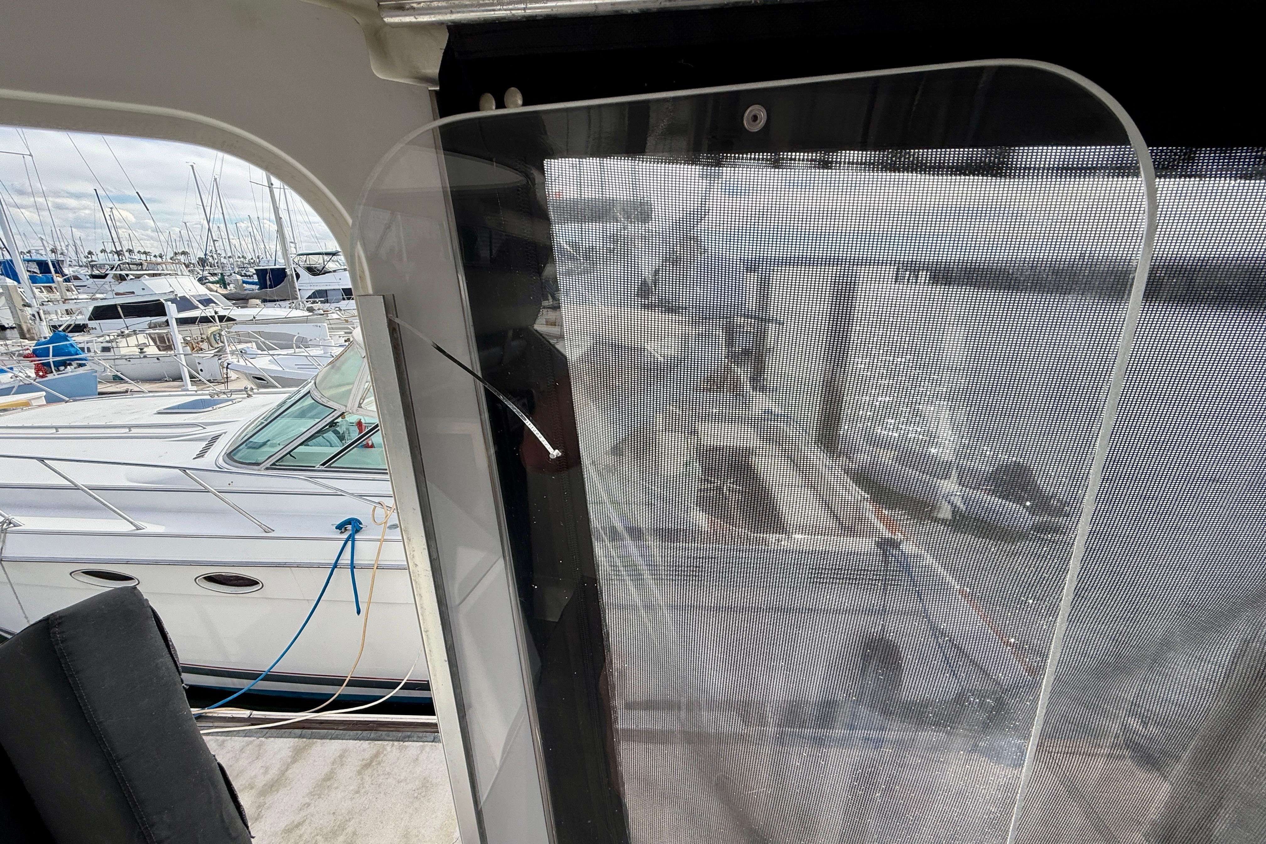 1997 Carver 355 Aft Cabin Motor Yacht docked at marina, view through cabin window.