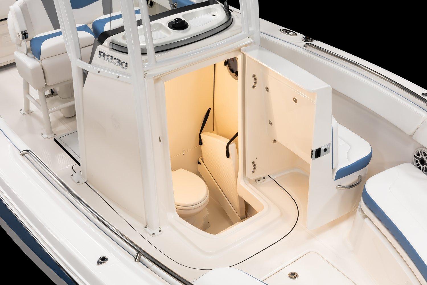 Manufacturer Provided Image: 2026 Robalo R230 Center Console boat interior with open compartment and seating.