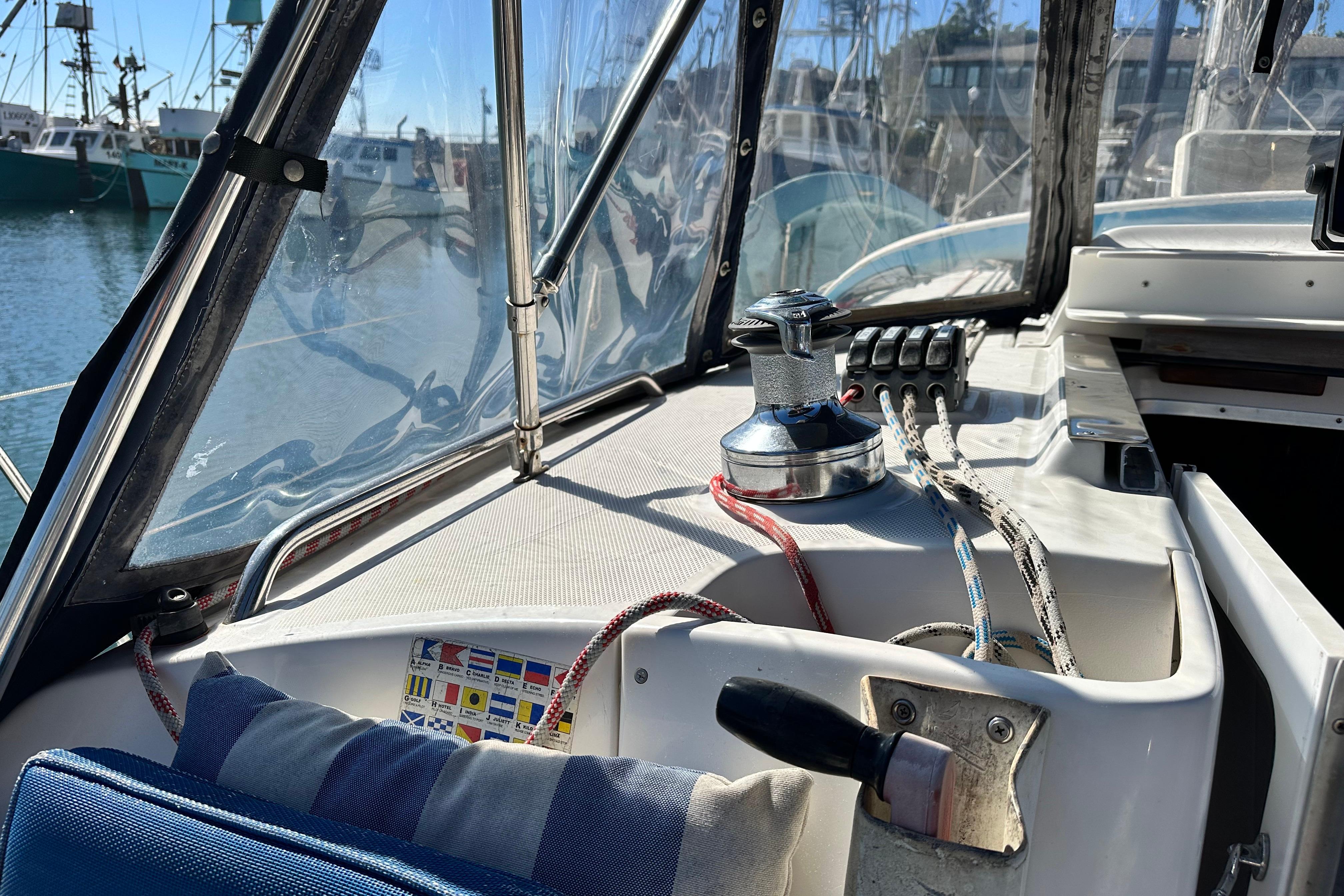 Cockpit of 2005 Hunter 41 AC sailboat with ropes and winch in marina.