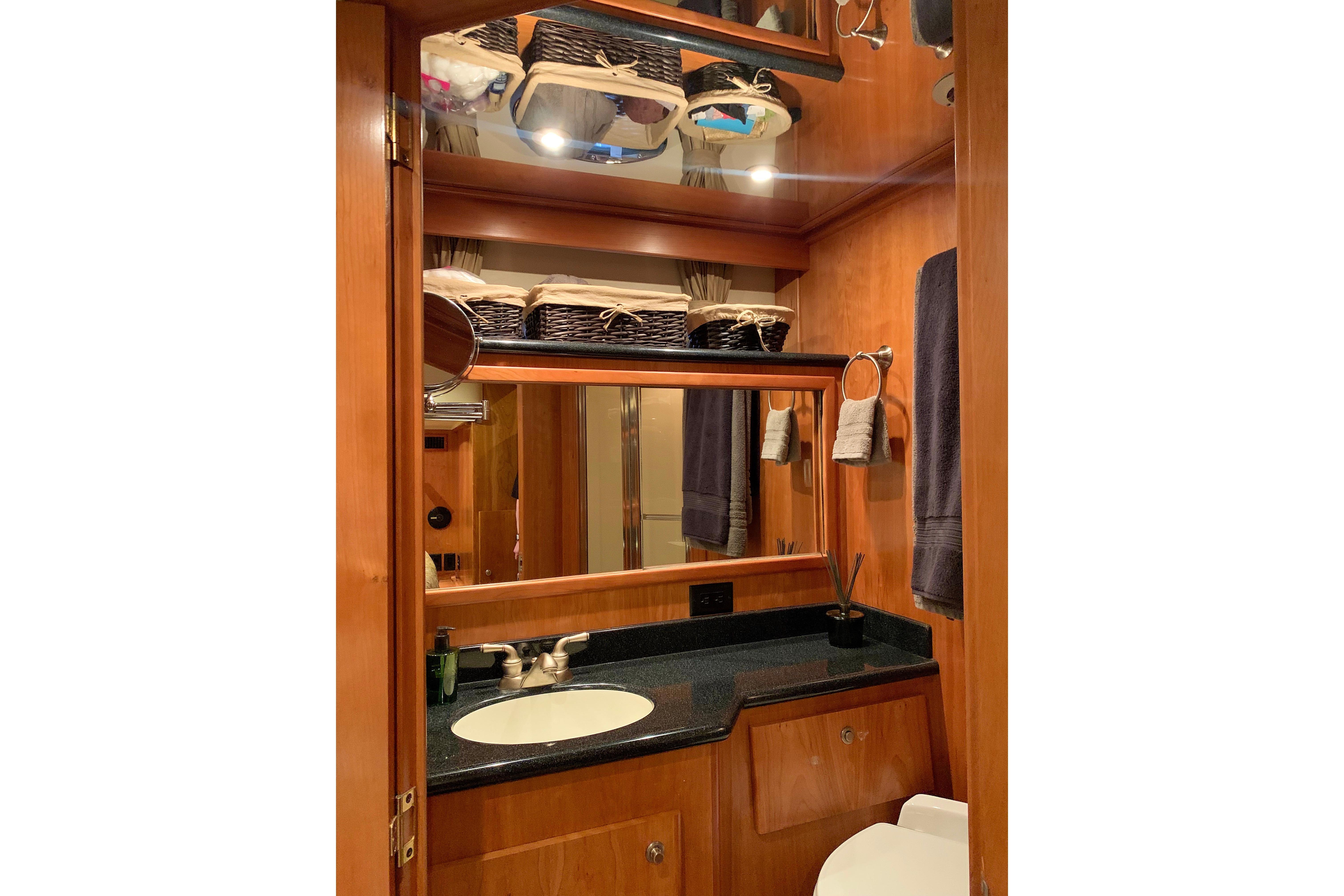 Luxurious 2007 Navigator 5100 yacht bathroom with wooden cabinetry and modern fixtures.