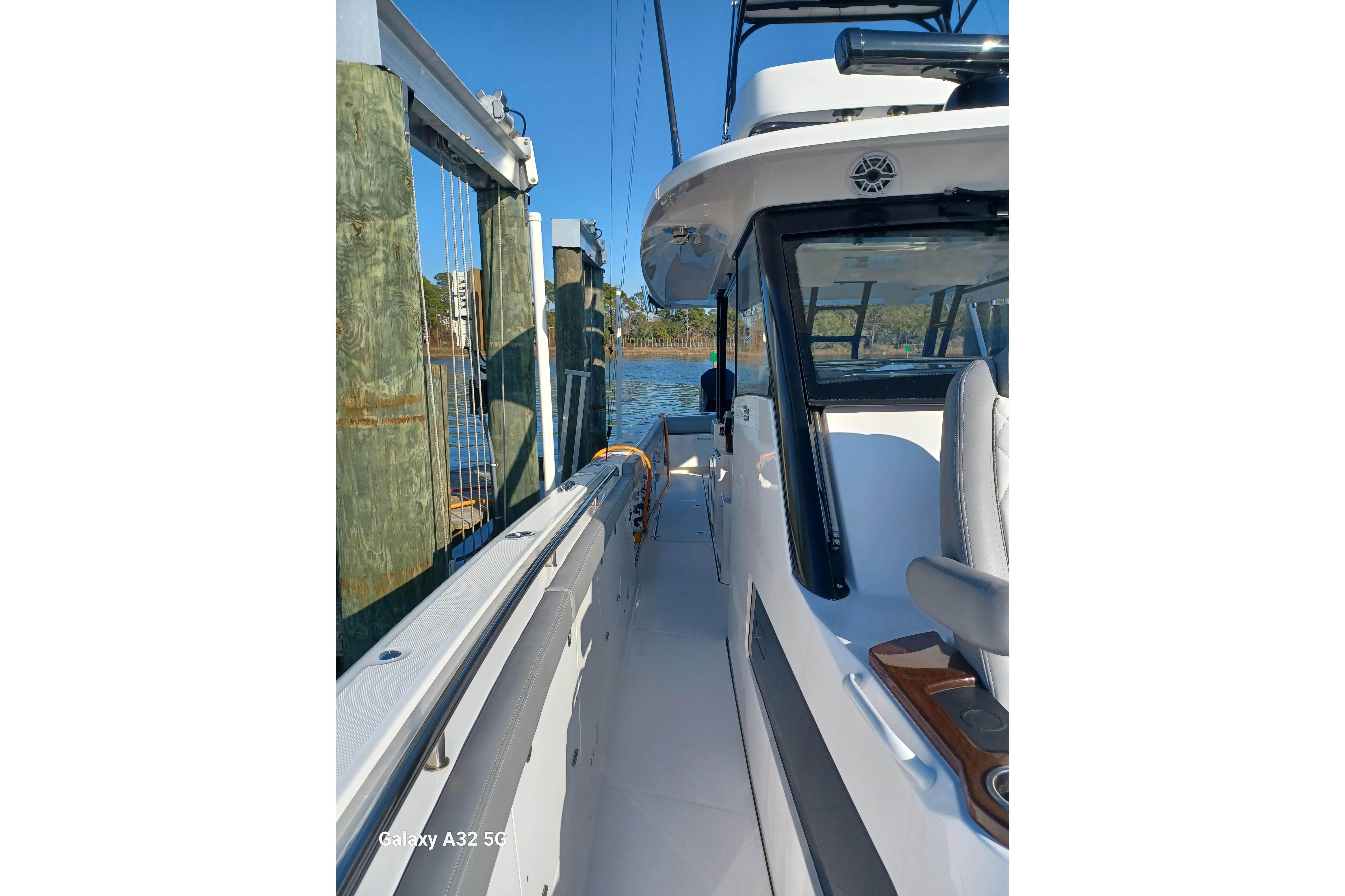 2024 Everglades 455 Center Console boat docked, showcasing sleek design and modern features.
