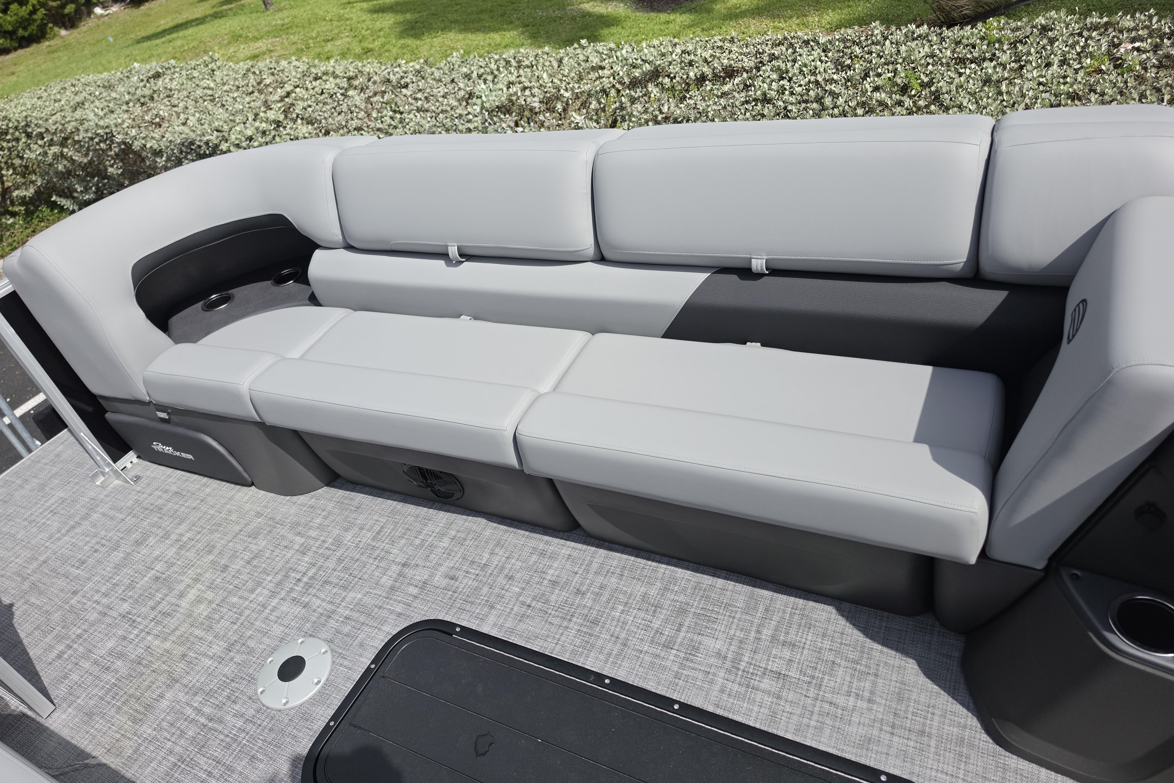 2026 Sun Tracker Party Barge 24 XP3 interior seating with gray upholstery and cup holders.