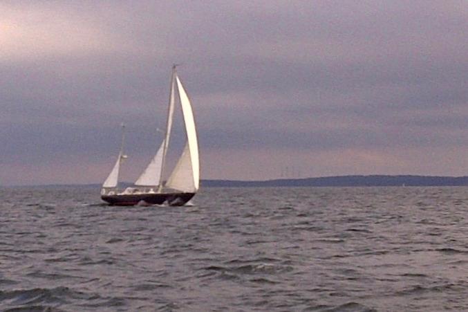 Sailing yacht Hinckley Bermuda 40 from 1970 on open water under cloudy skies.