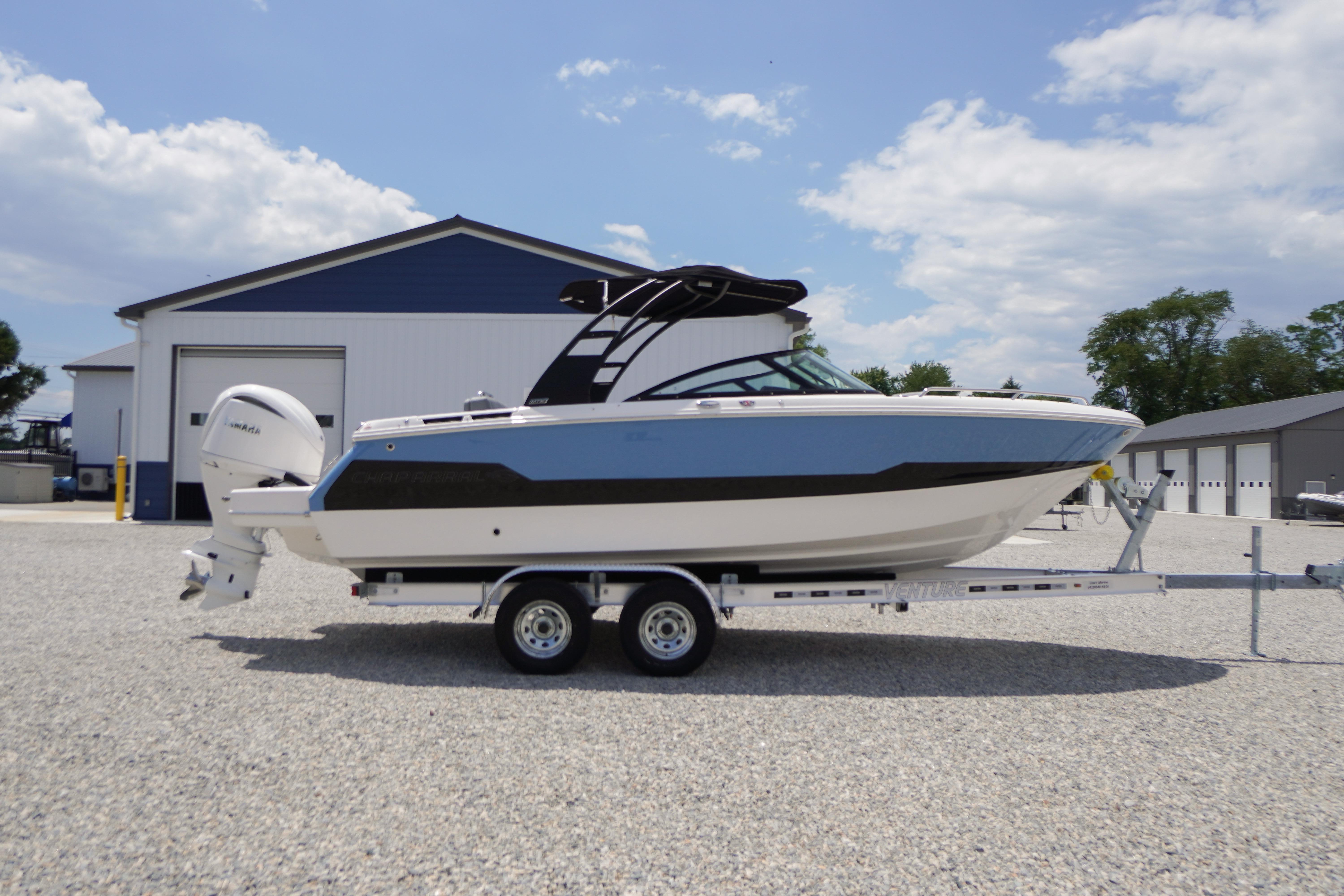 2026 Chaparral SSX 4 boat on trailer, parked outdoors near a building.
