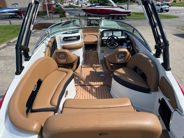 2024 Crownline Eclipse E255 boat interior with tan seating and modern dashboard.