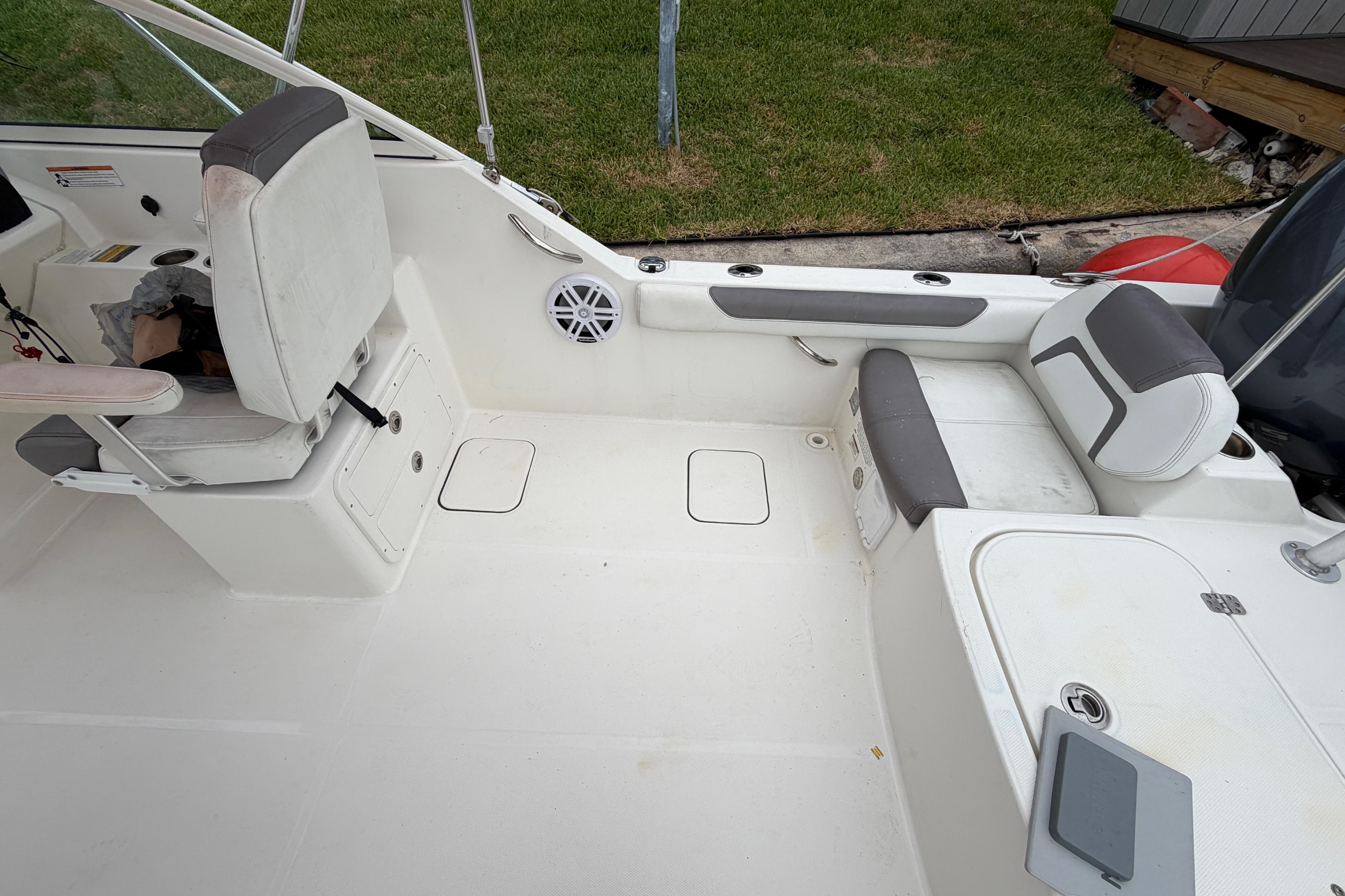 2019 World Cat 230 DC boat interior with seating and storage compartments.