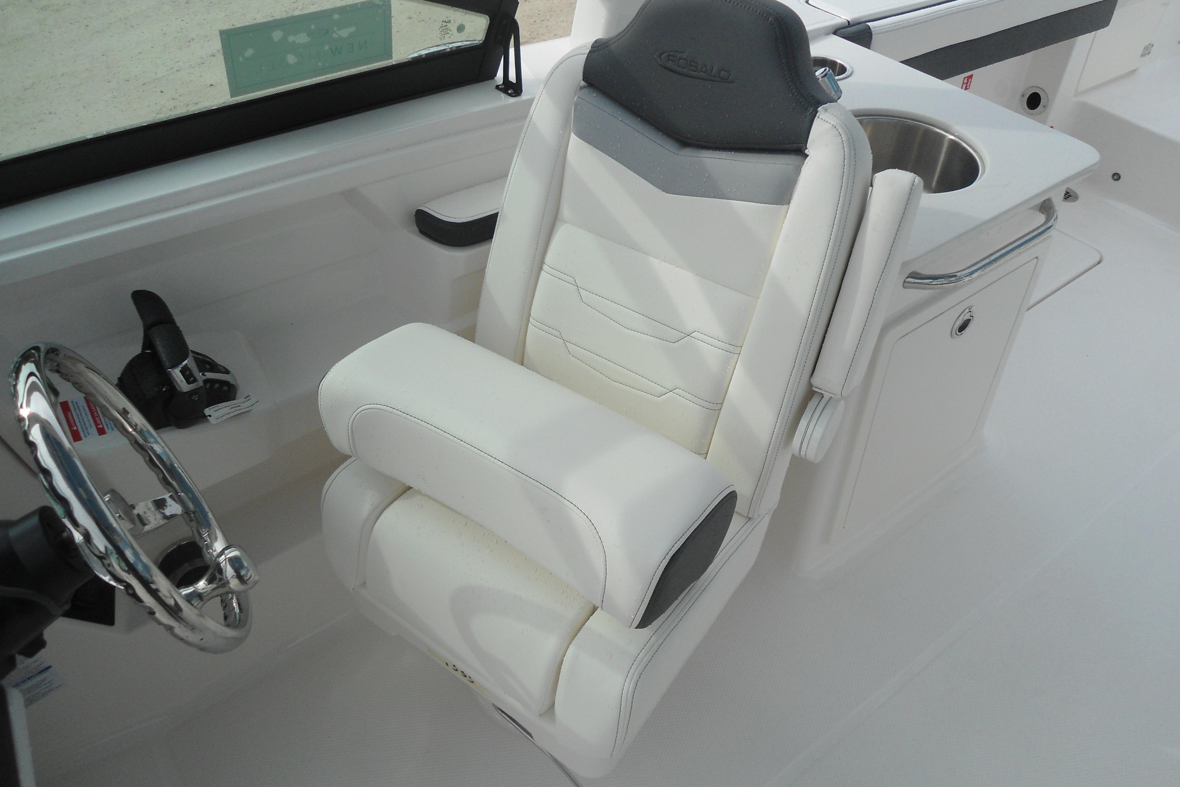 2026 Robalo R257 Dual Console boat interior with steering wheel and white captain's chair.