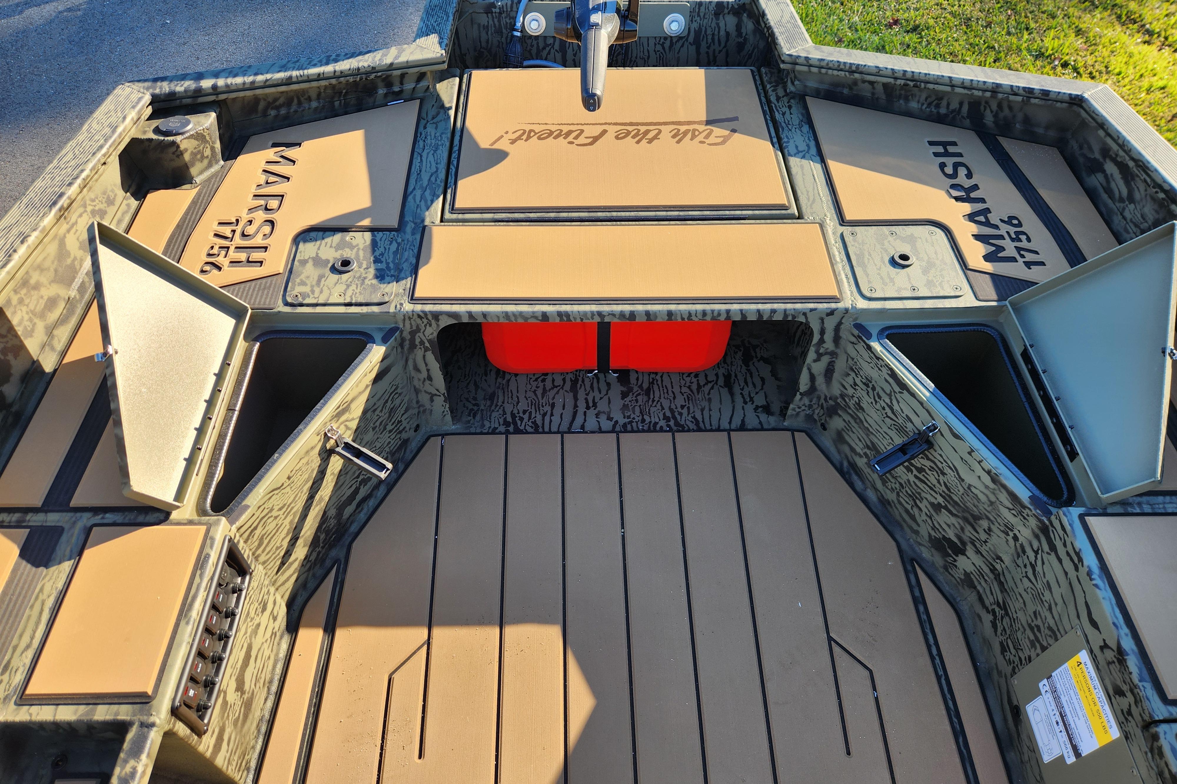 2026 Tracker Grizzly 1756 T Marsh boat interior with storage compartments open.