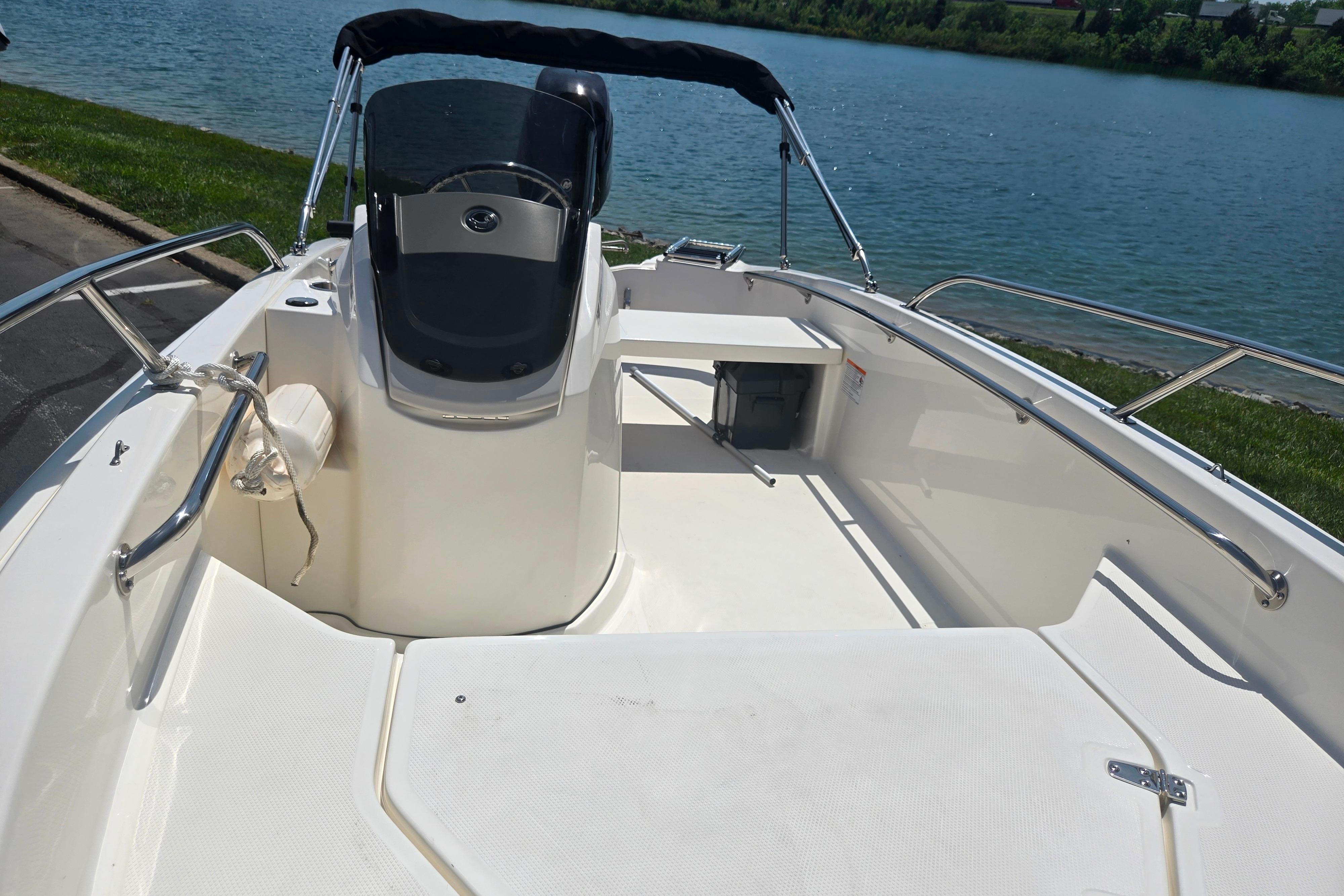 2025 Boston Whaler 130 Super Sport boat interior by a lake.