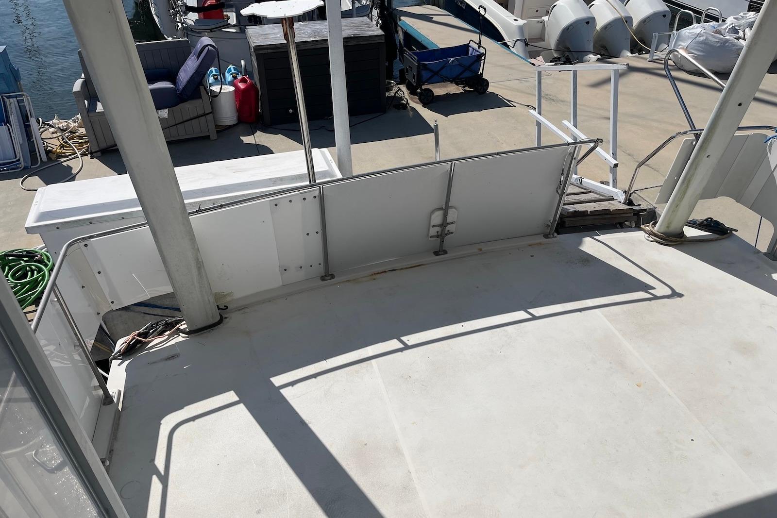 1992 Carver 33 Aft Cabin Motor Yacht deck with marina view and docked boats.