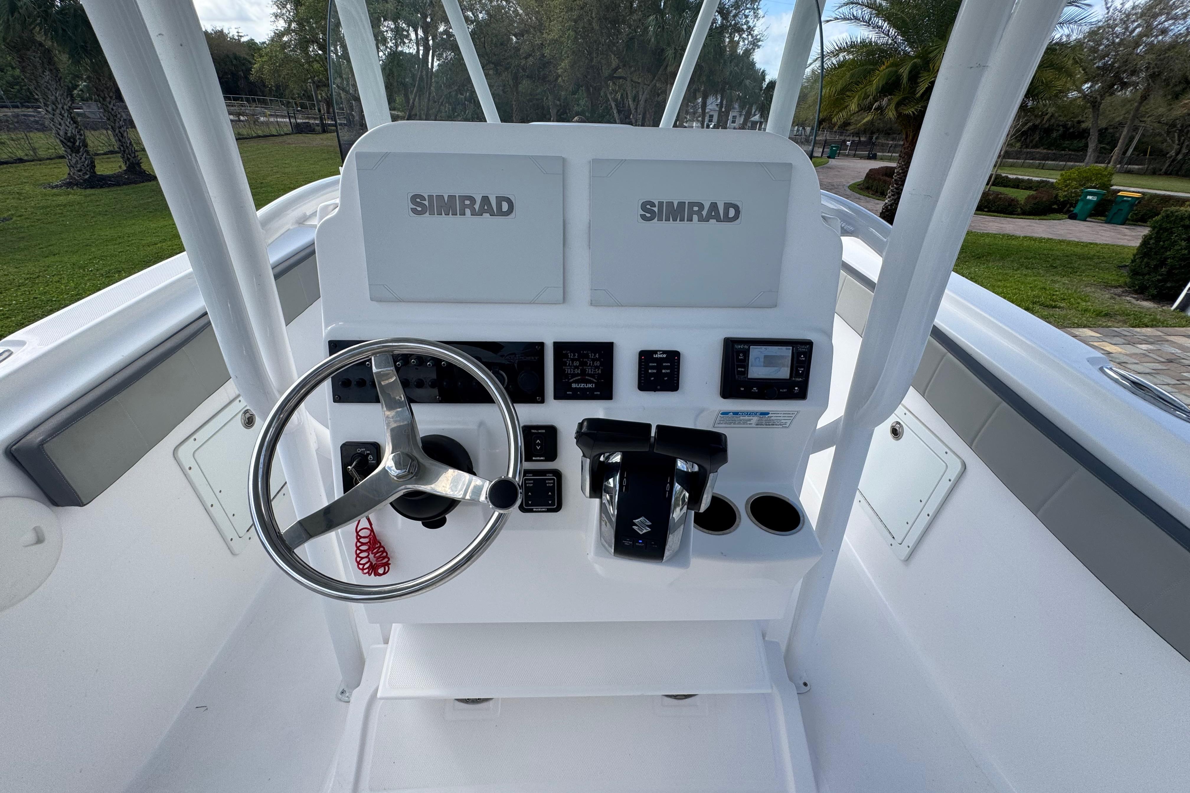 2022 Aquasport 2500 Center Console boat dashboard with Simrad electronics and steering wheel.