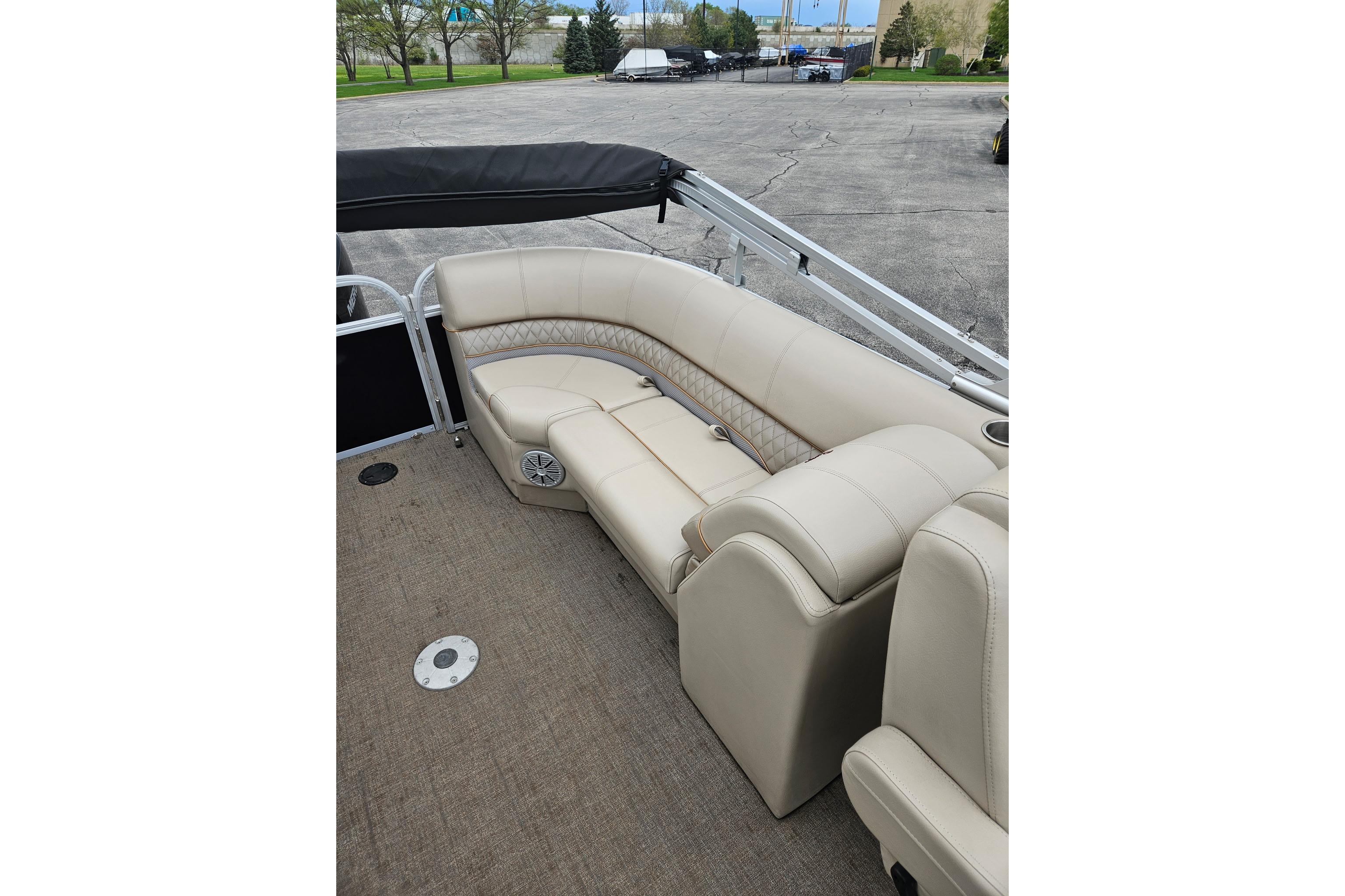 2023 Ranger Reata 243C boat interior with beige seating and speaker system.