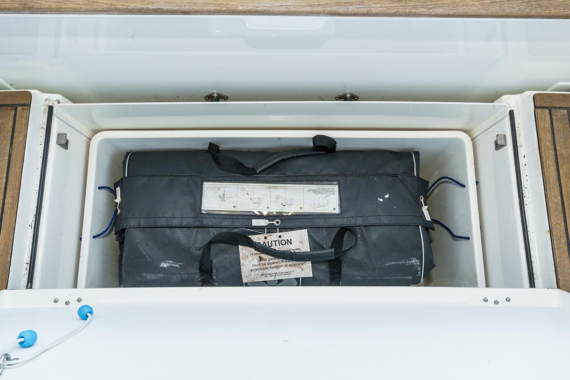 Storage compartment on a 2017 Beneteau Sense 50 yacht with a black bag inside.